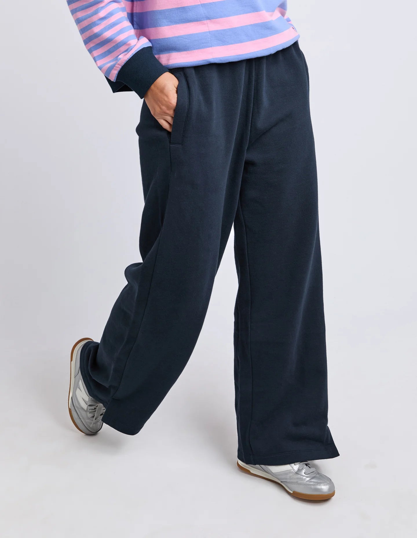 Image of Woman wearing Elm  navy blue sweatpants on a white background