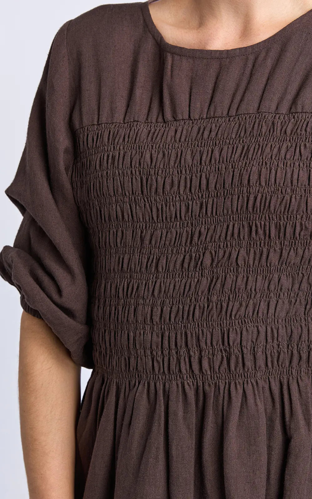 Image of Elm Brown dress with smocked bodice on a white background