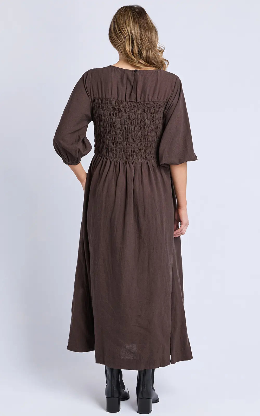 Elm brown dress worn by a woman on a white background
