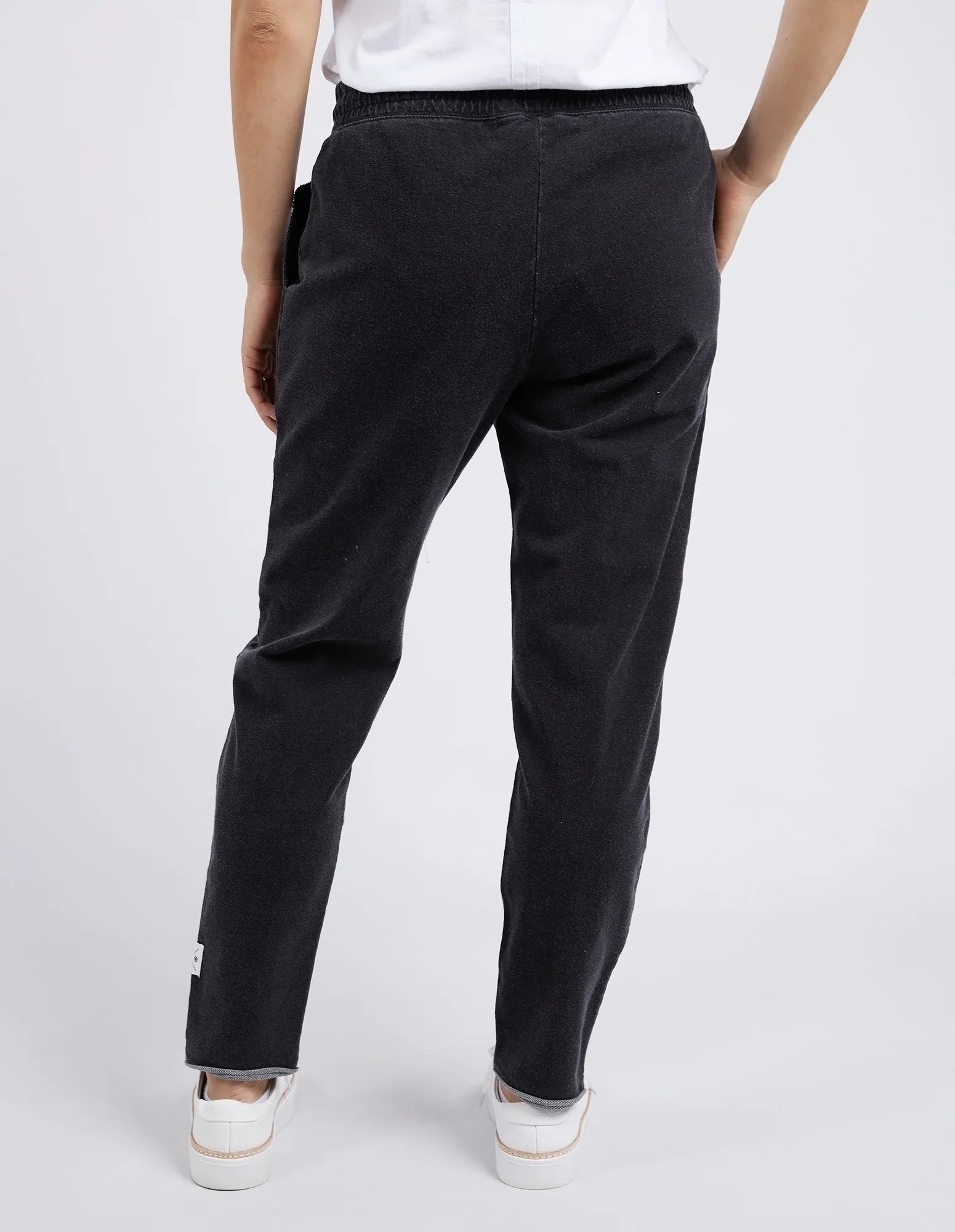Woman wearing Elm black pants on a white background