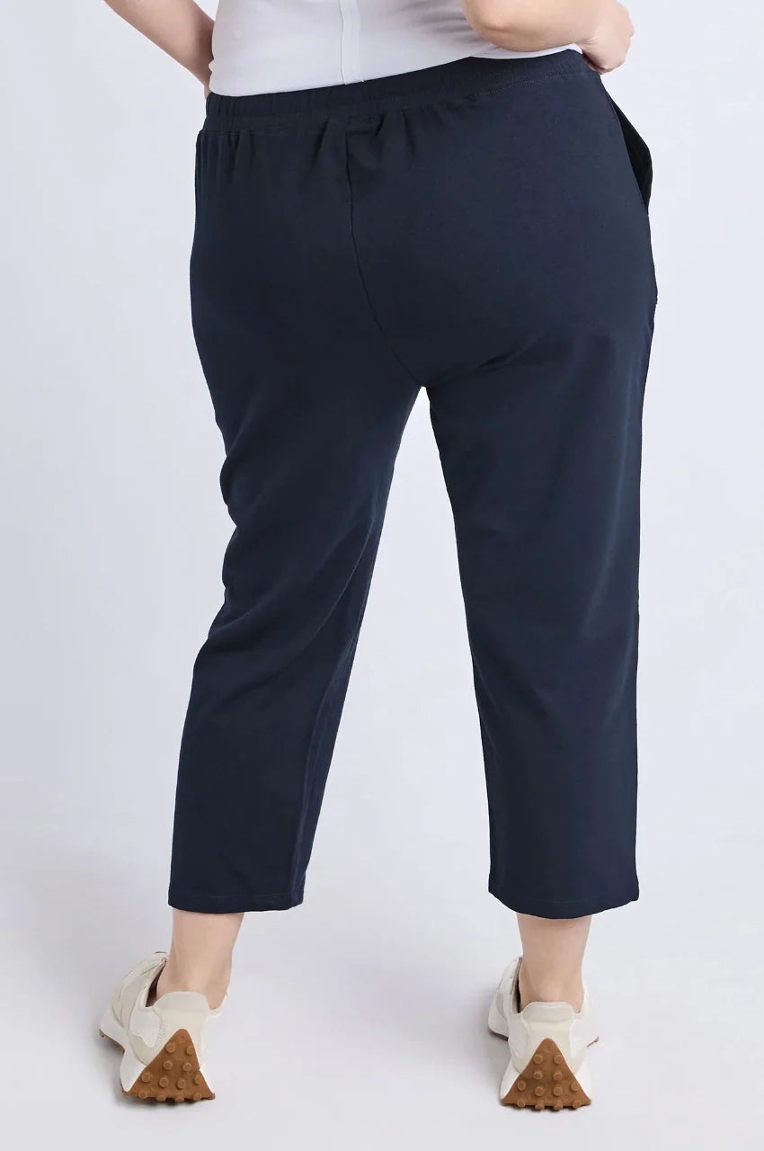 Image of Navy blue pants worn by a woman on a white background