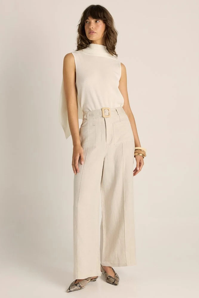 Image of Woman wearing a Fate & Becker white sleeveless top and beige wide-leg pants on a plain background