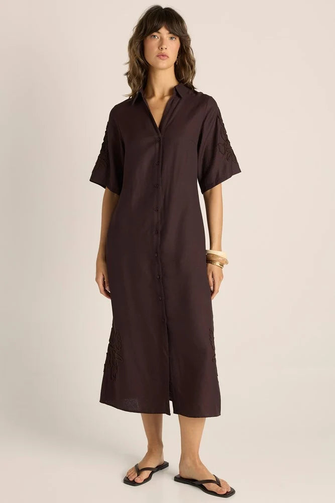 Image of Woman wearing a Fate & Becker brown dress against a plain background
