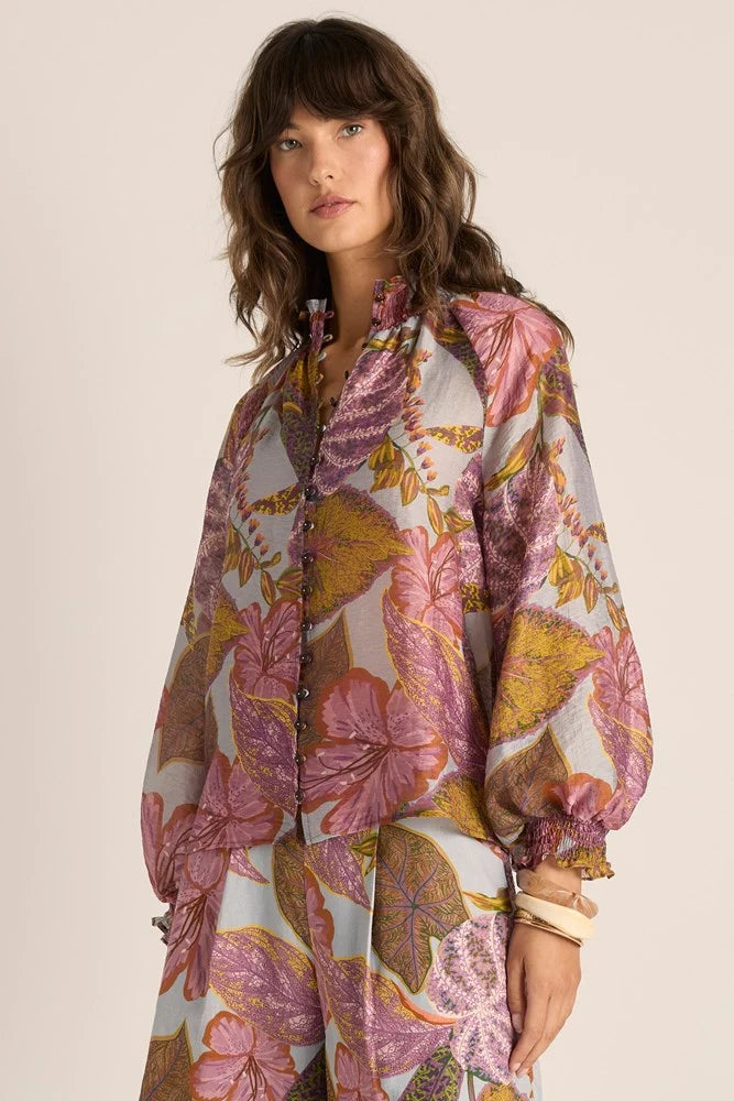 Image of Woman wearing a Fate & Becker floral patterned outfit on a beige background