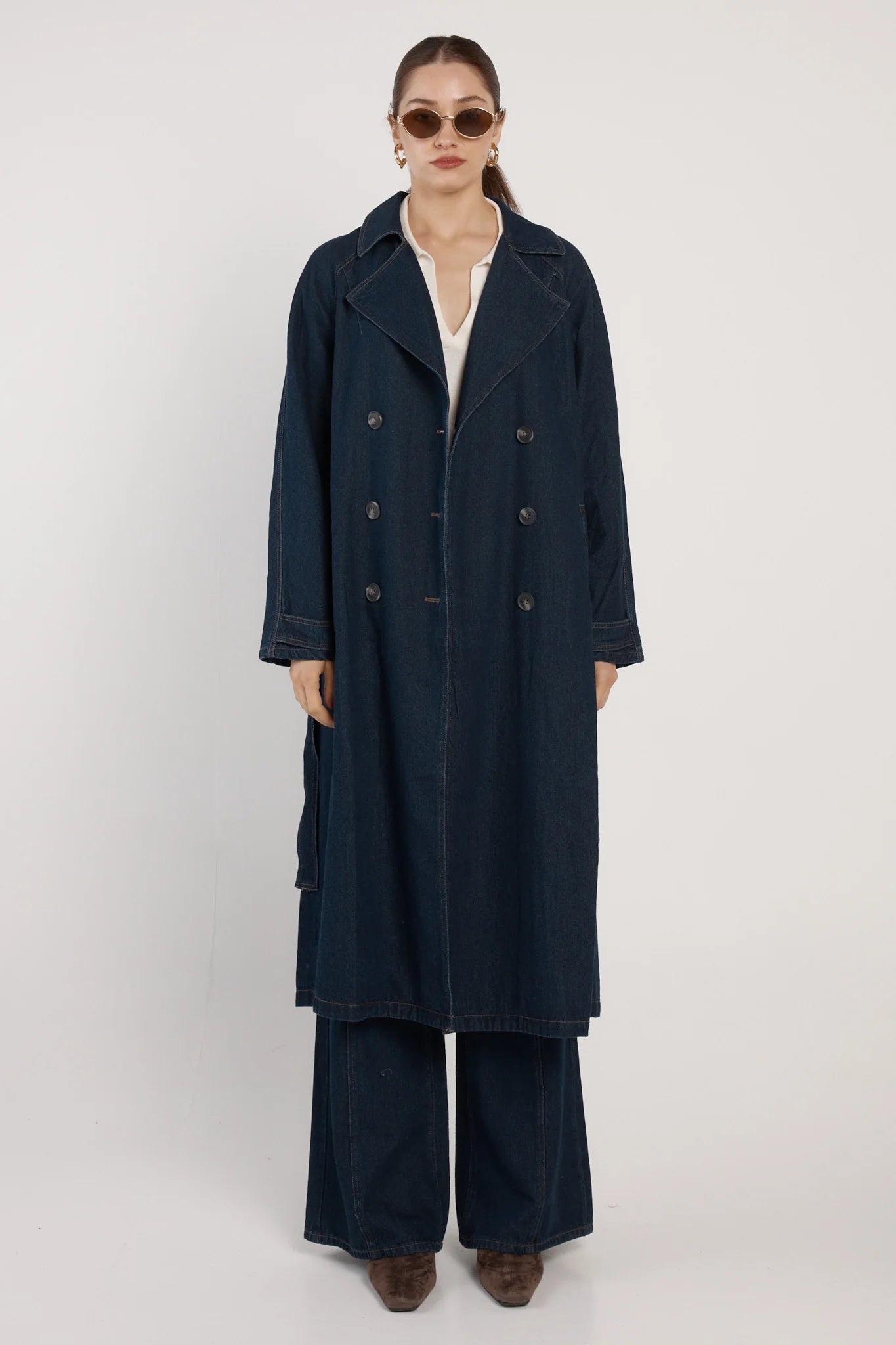 Image of Woman wearing a Fate & Becker long navy coat on a white background
