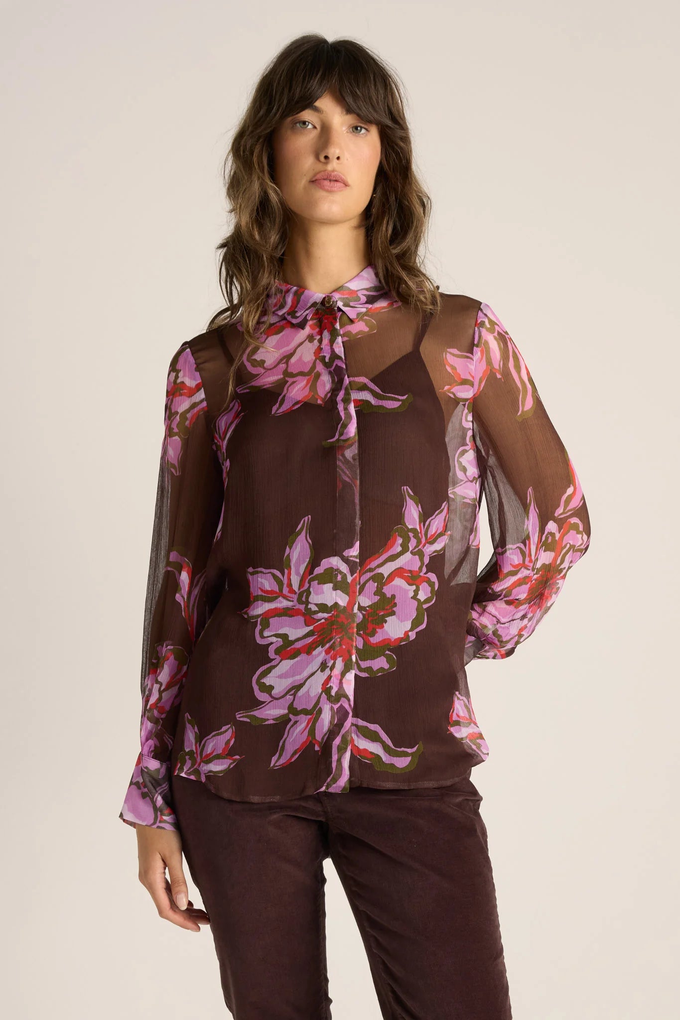 Image of Woman wearing a Fate and Becker brown floral blouse with a plain background