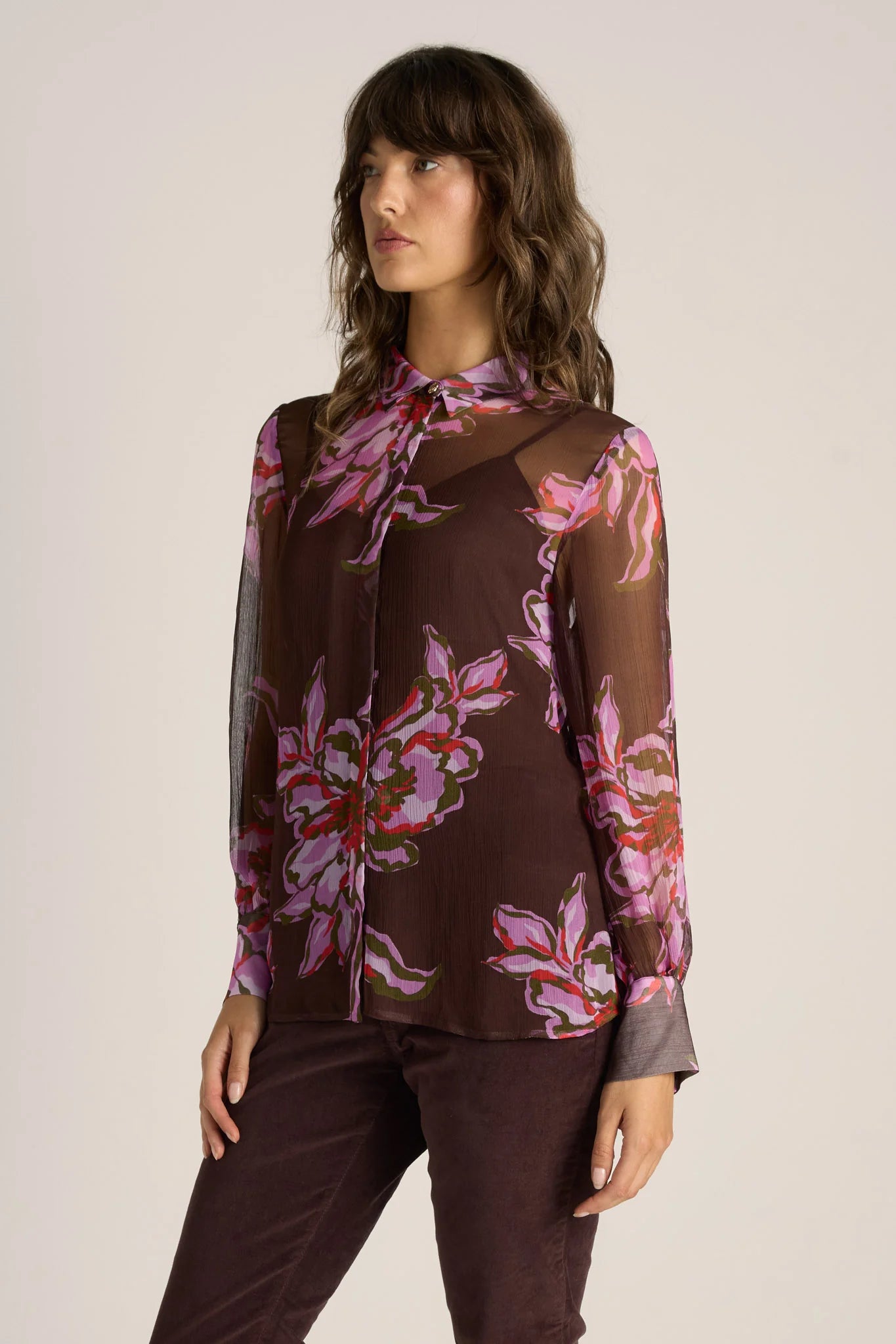 Image of Woman wearing a Fate and Becker brown floral blouse with a plain background