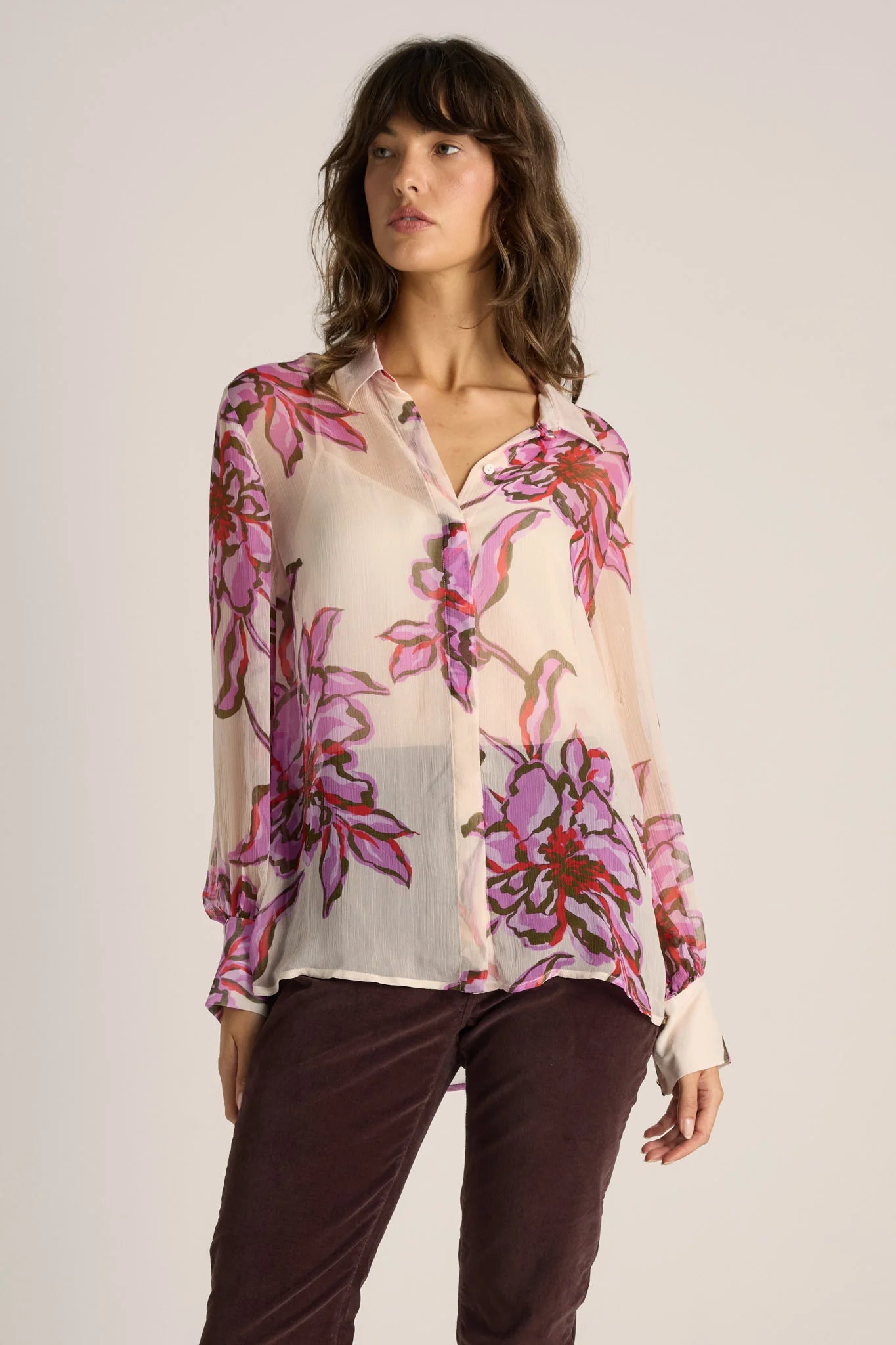 Image of Woman wearing a Fate & Becker floral blouse with a plain background