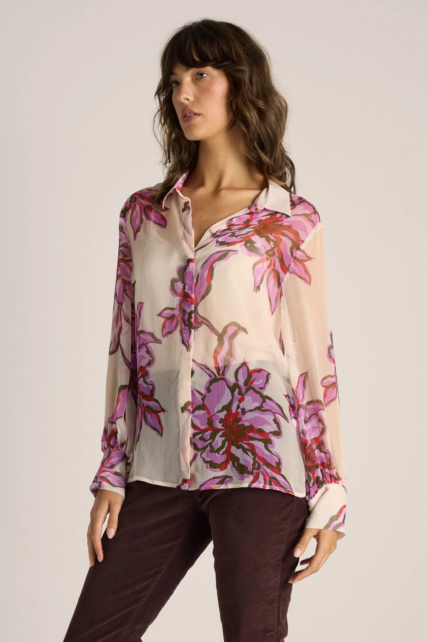 Image of Woman wearing a Fate & Becker floral blouse with a plain background
