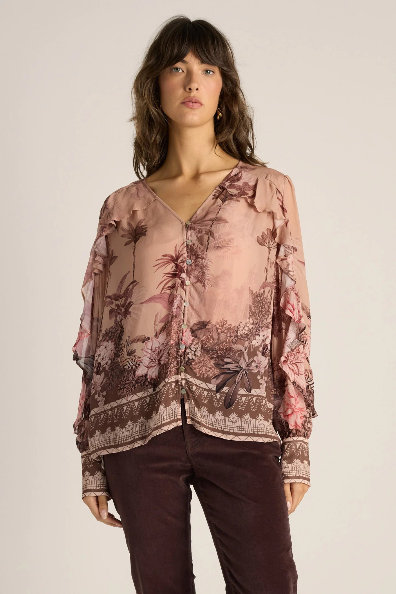 Image of Woman wearing a Fate & Becker floral blouse with a neutral background