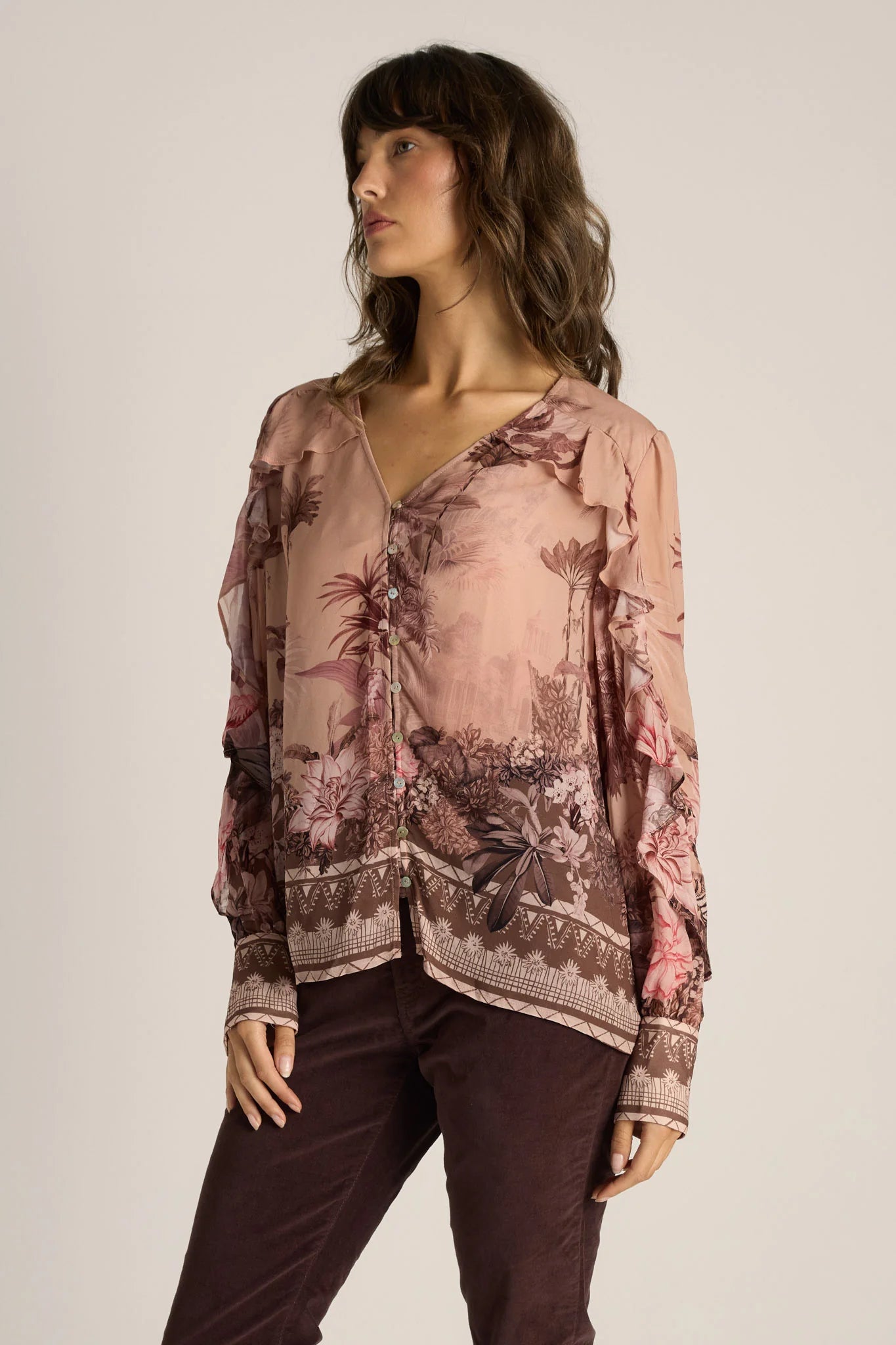 Image of Woman wearing a Fate & Becker floral blouse with a neutral background