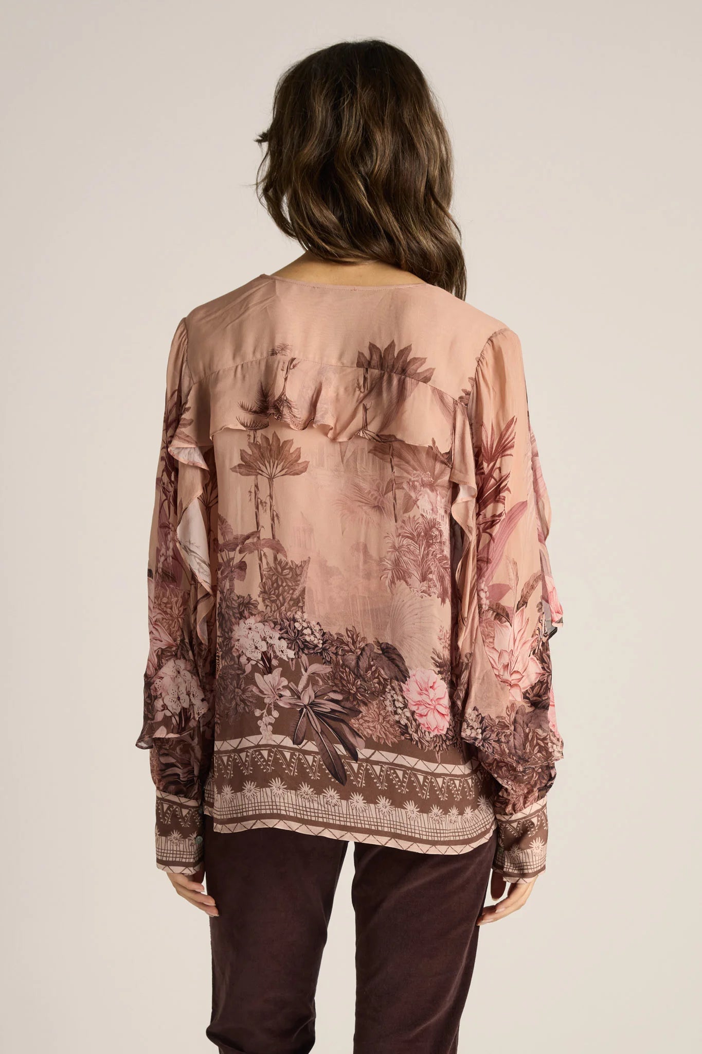 Image of Woman wearing a Fate & Becker floral blouse with a neutral background