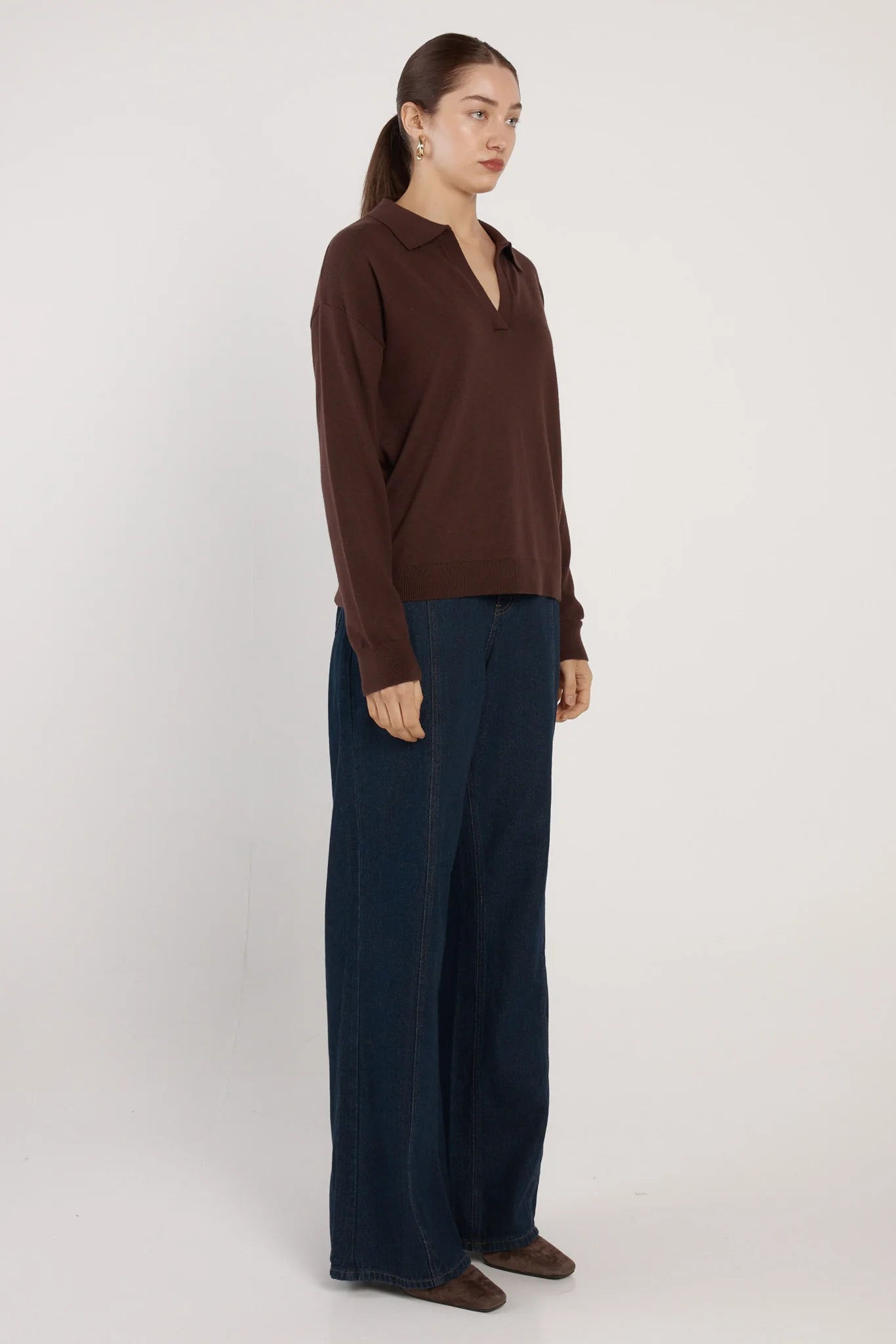 Image of Woman wearing a Fate and Becker brown blouse and navy pants on a white background