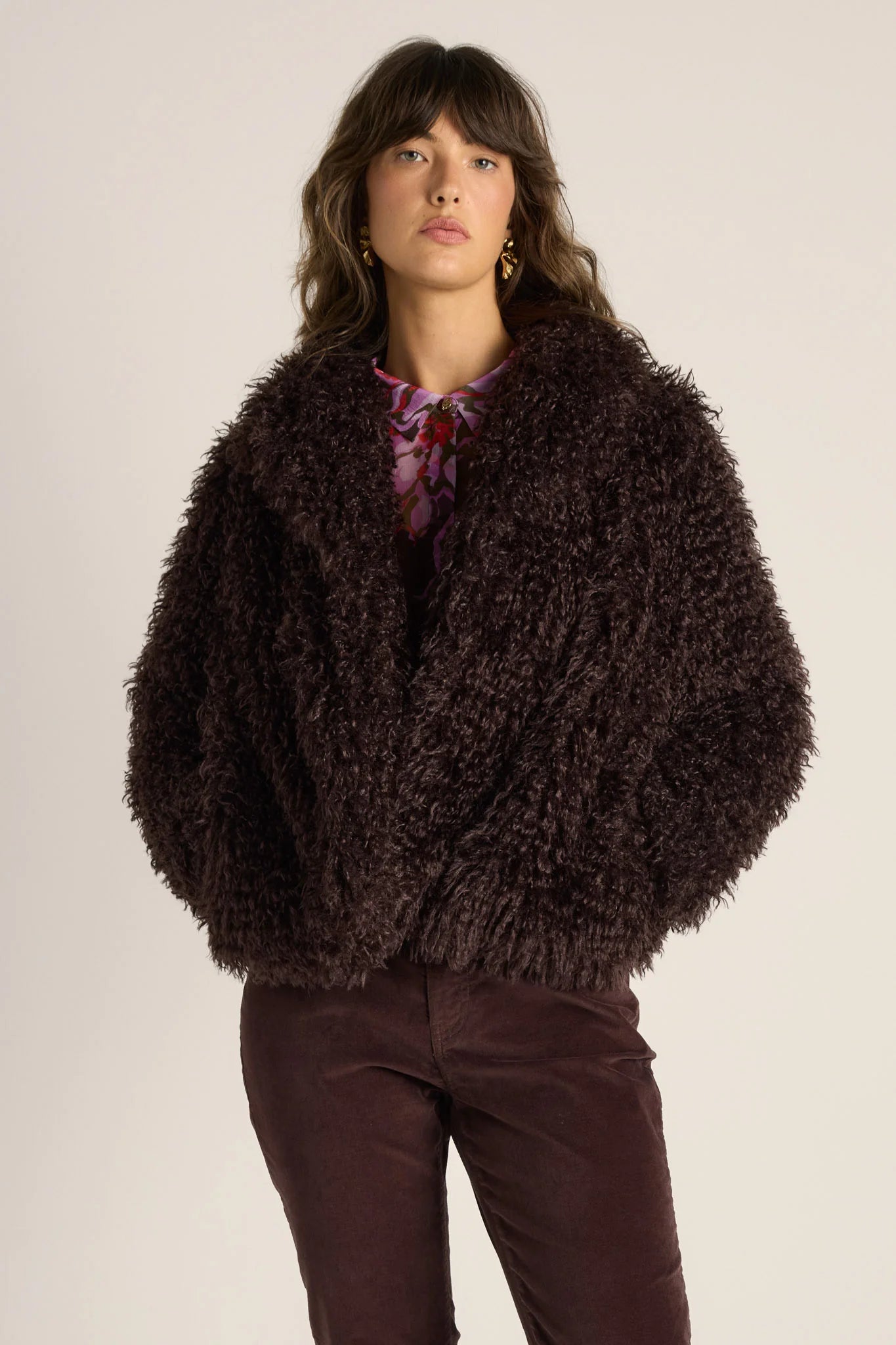 Image of Woman wearing a Fate & Becker brown fuzzy jacket against a plain background