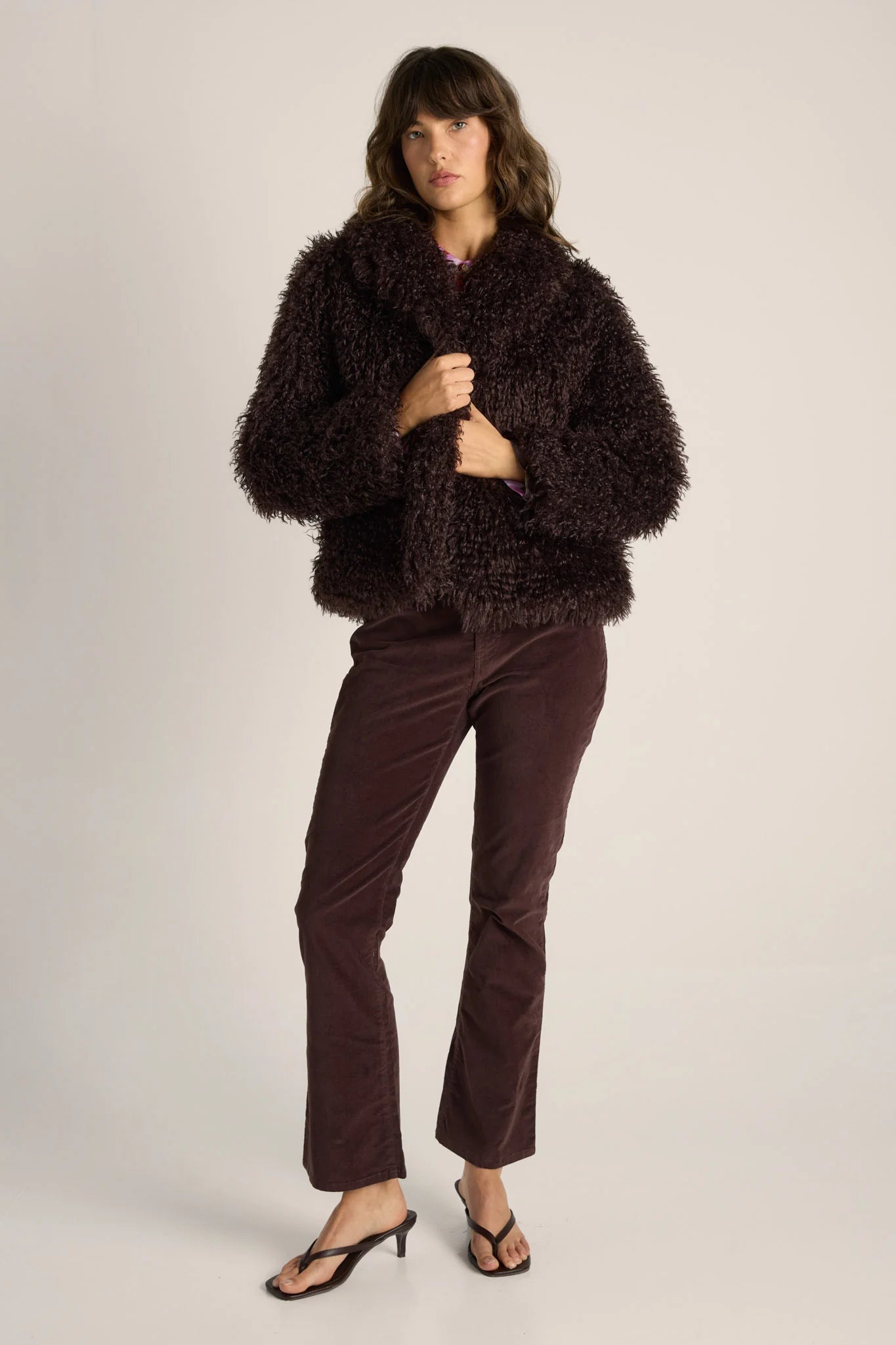 Image of Woman wearing a Fate & Becker brown fuzzy jacket and pants on a plain background