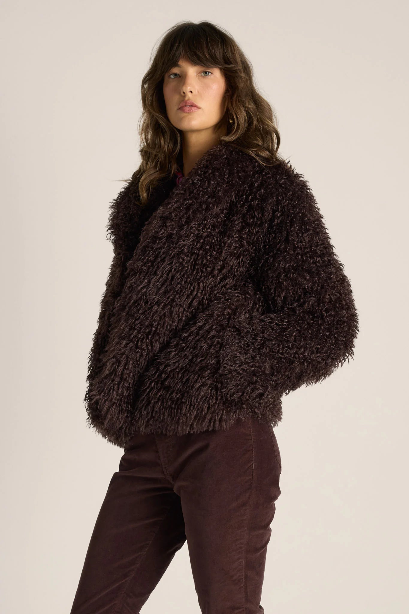 Image of Woman wearing a Fate & Becker brown fuzzy jacket against a plain background