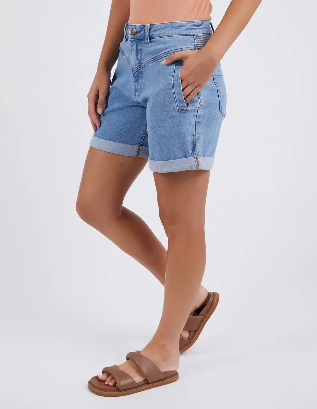 A model wearing Foxwood light blue denim shorts with rolled cuffs and brown slide sandals, shown from the waist down against a plain white studio background.