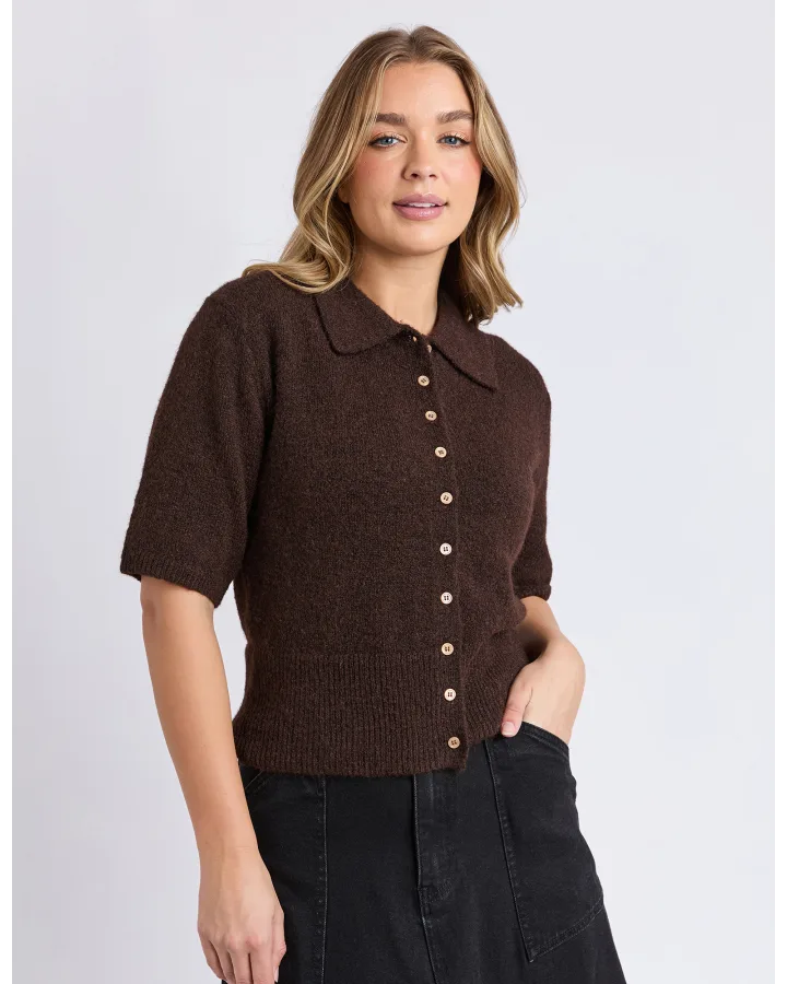 Image of Woman wearing a Foxwood brown knitted shirt with a collar on a light gray background