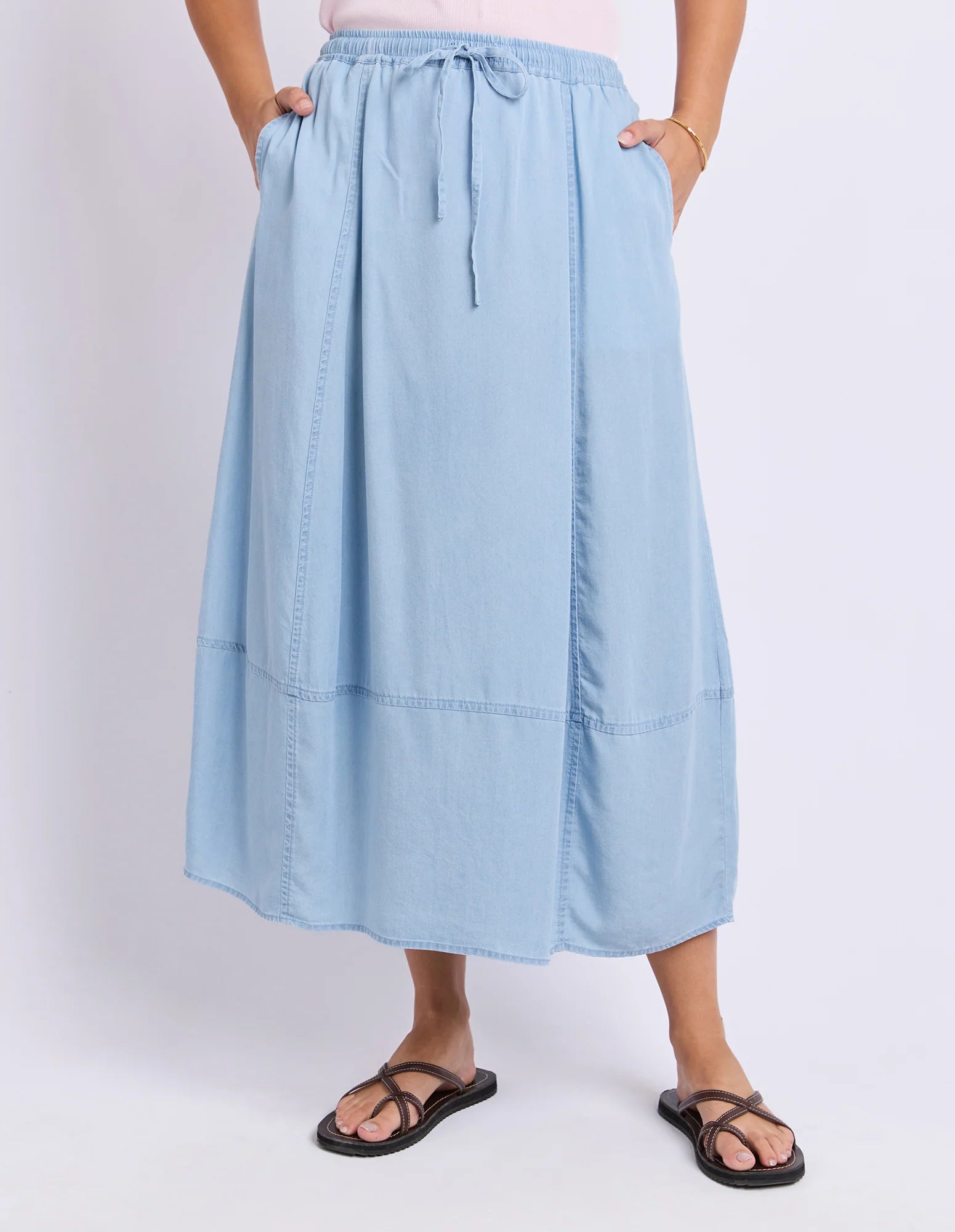 Image of Foxwood light blue skirt worn by a woman on a white background