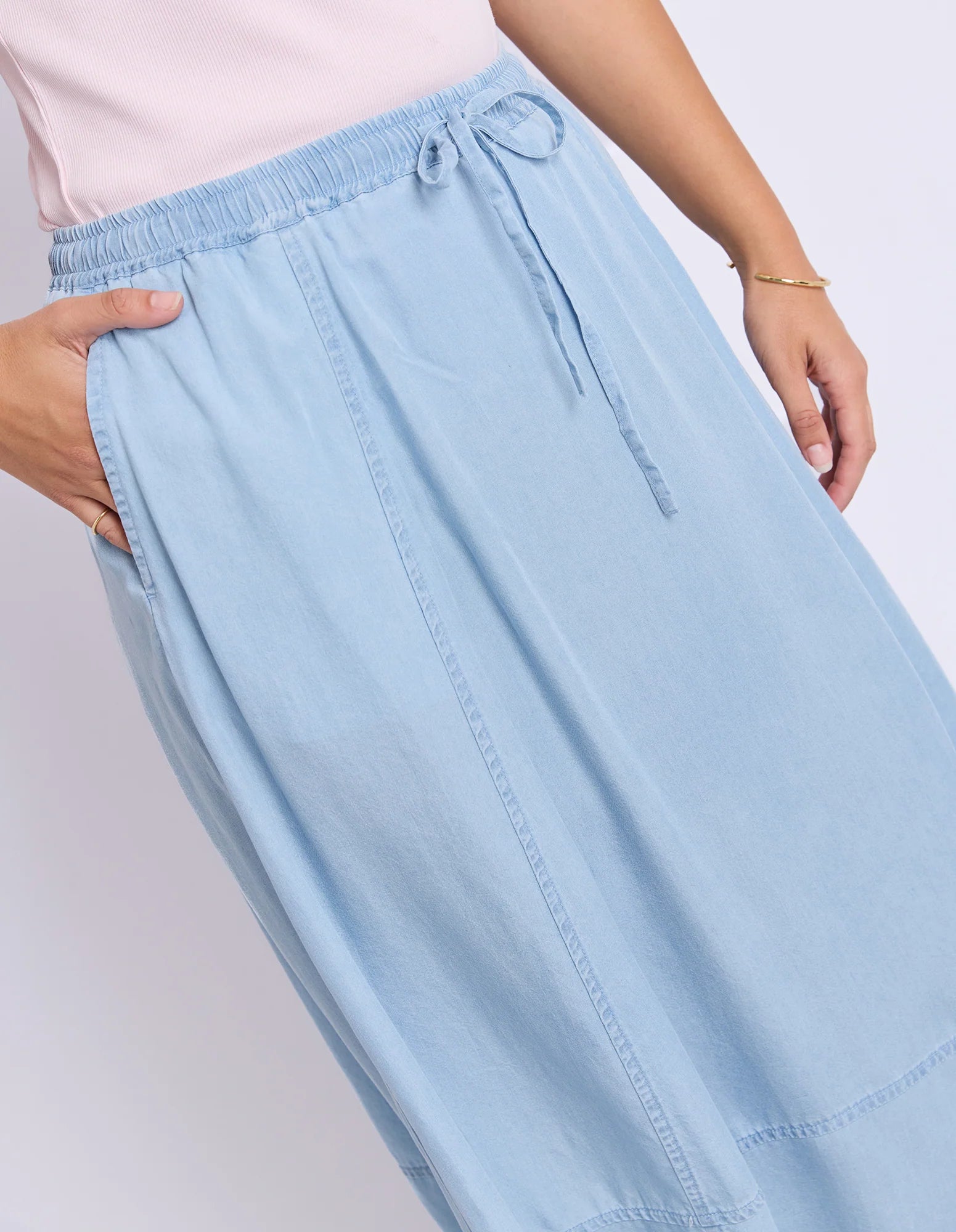Image of Foxwood light blue denim skirt worn by a woman on a plain background