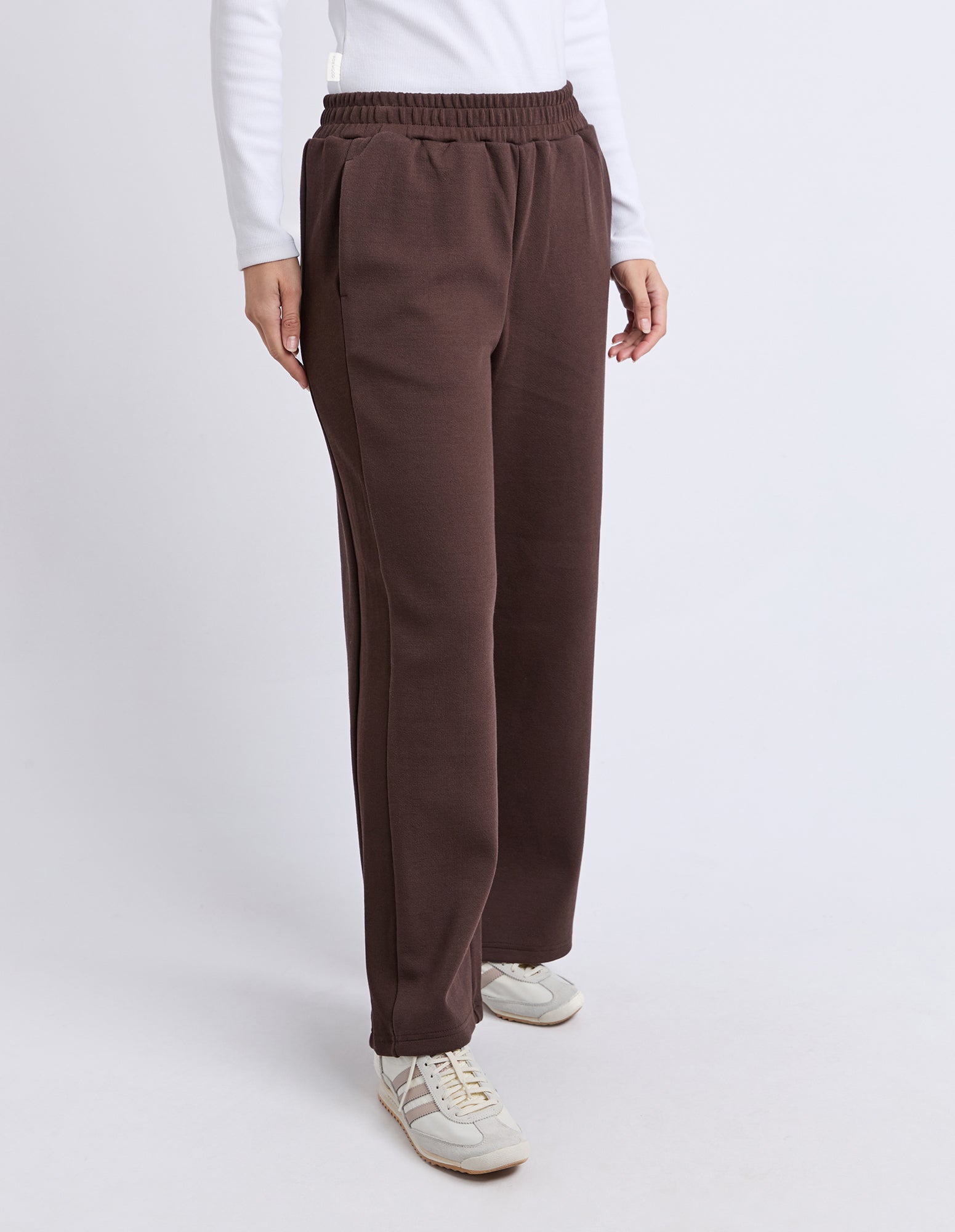 Image of Woman wearing Foxwood brown pants worn by a person on a white background