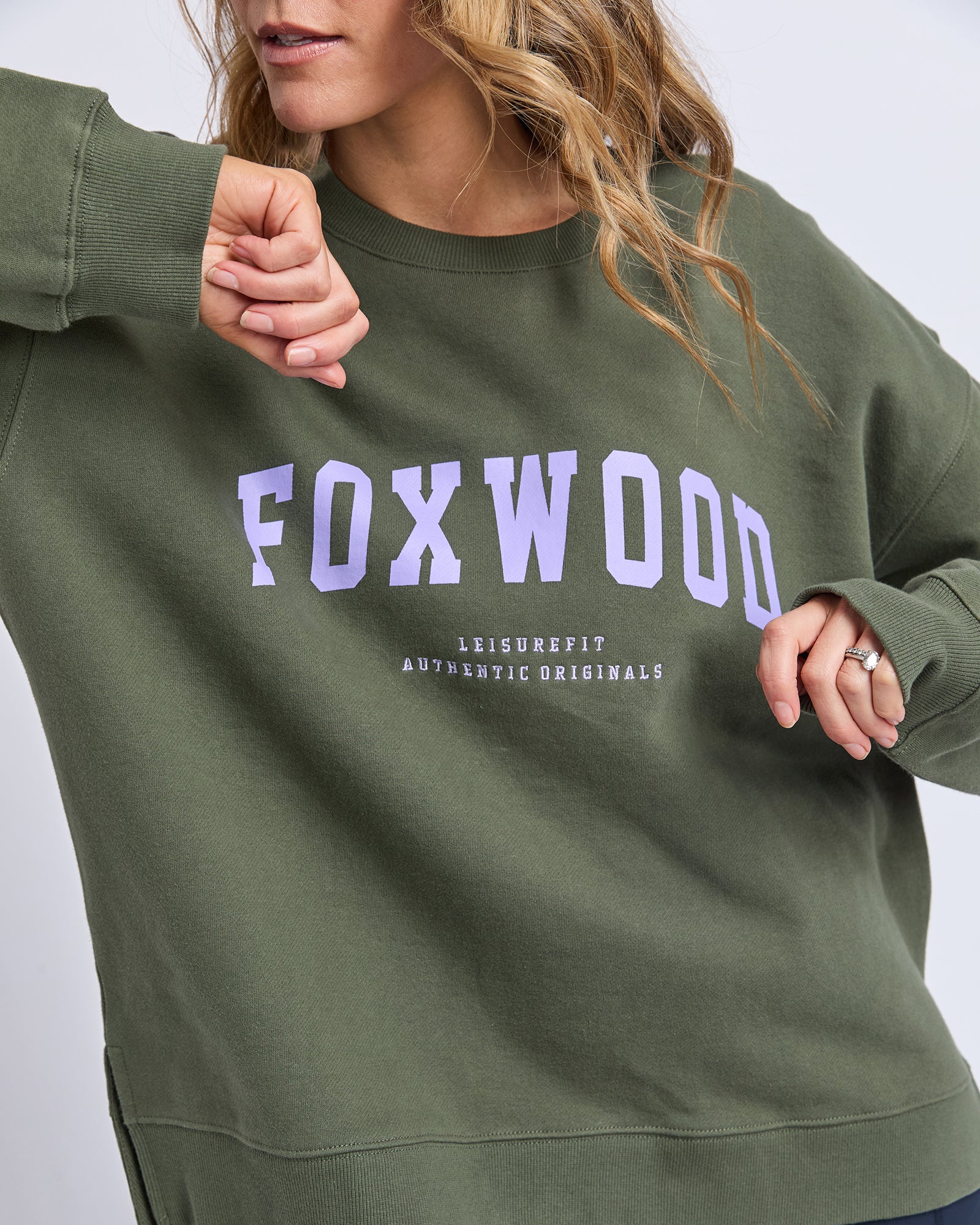 Image of Green sweatshirt with 'FOXWOOD' printed on it against a neutral background
