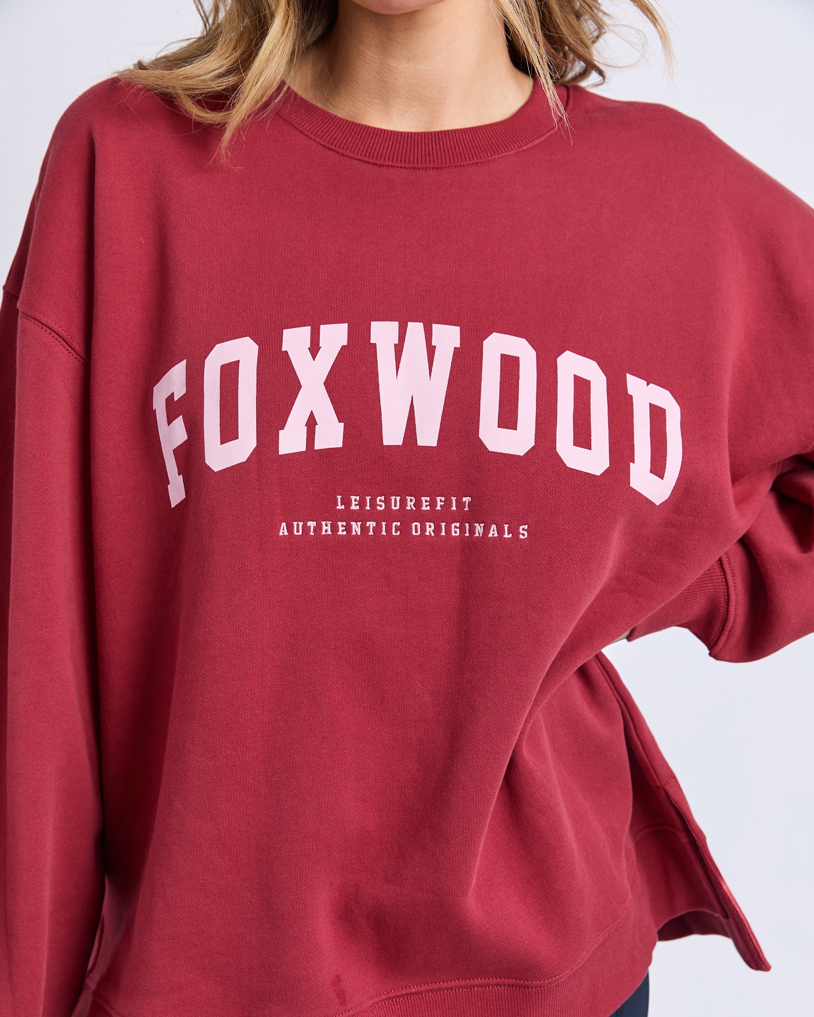 Image of Red sweatshirt with 'FOXWOOD' branding on a white background