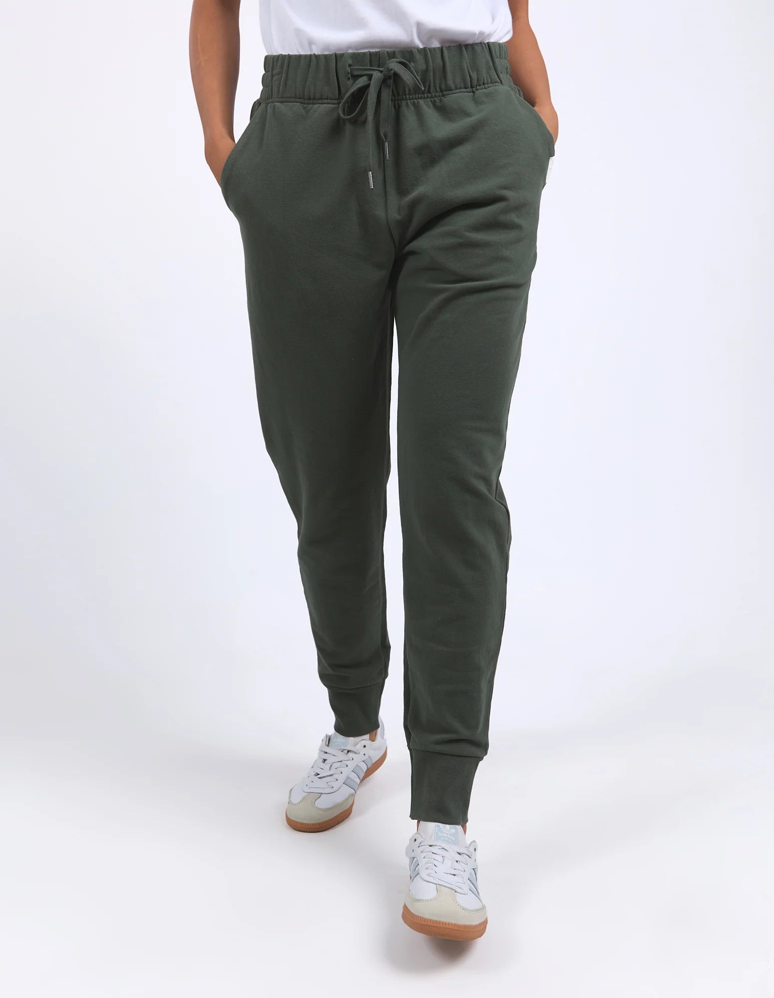 Image of Woman wearing Foxwood khaki jogger pants on a white background
