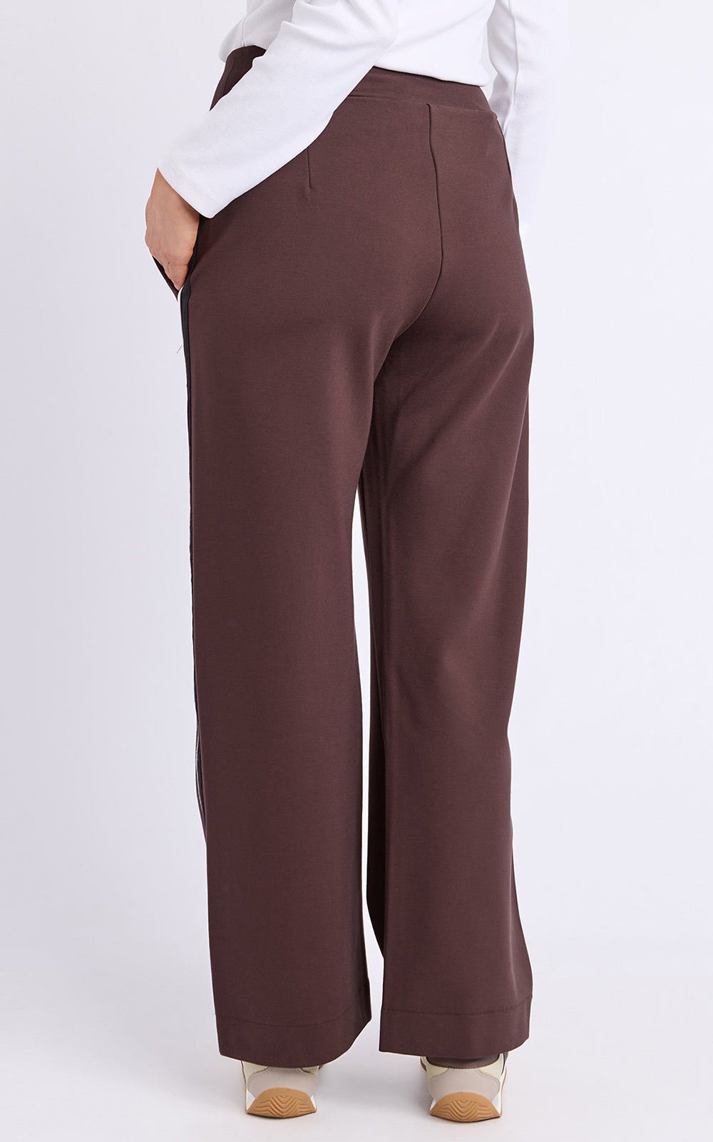 Foxwood brown wide-leg pants worn with a white shirt on a light gray background
