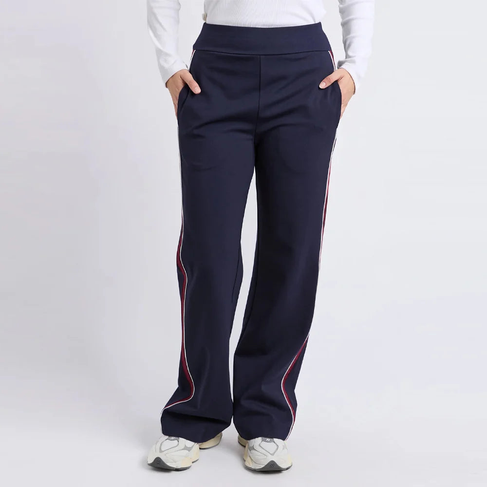 Image of Foxwood navy pants with red stripes worn by a woman on a white background