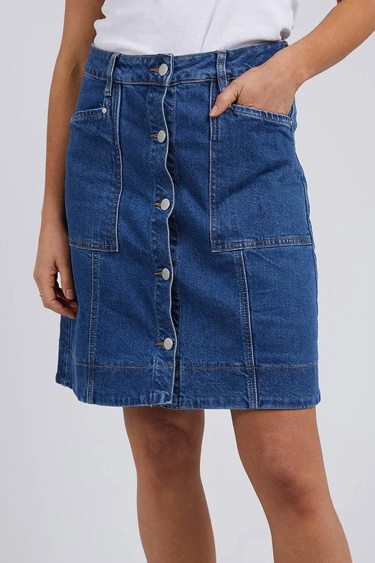 Foxwood Blue denim skirt worn by a woman on a white background