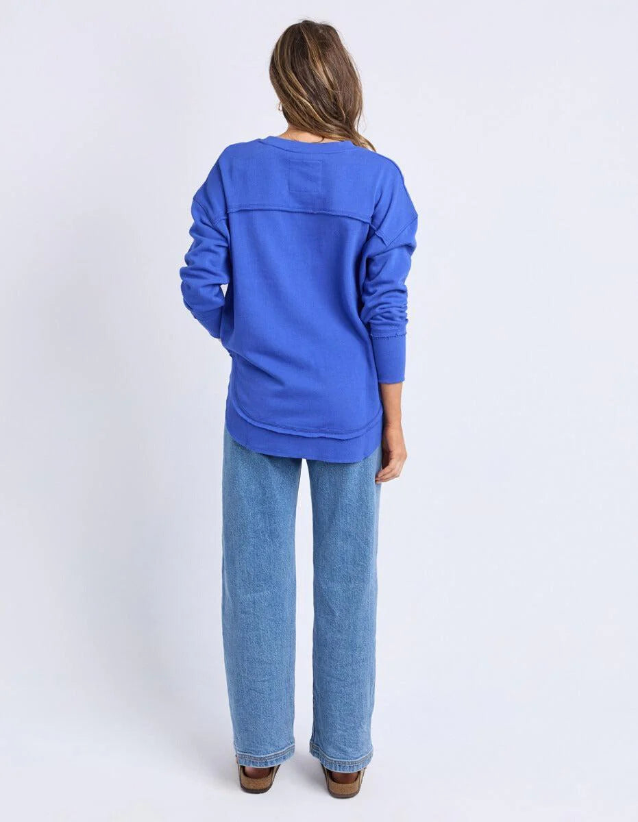 Image of Woman wearing a Foxood blue sweatshirt and jeans on a white background