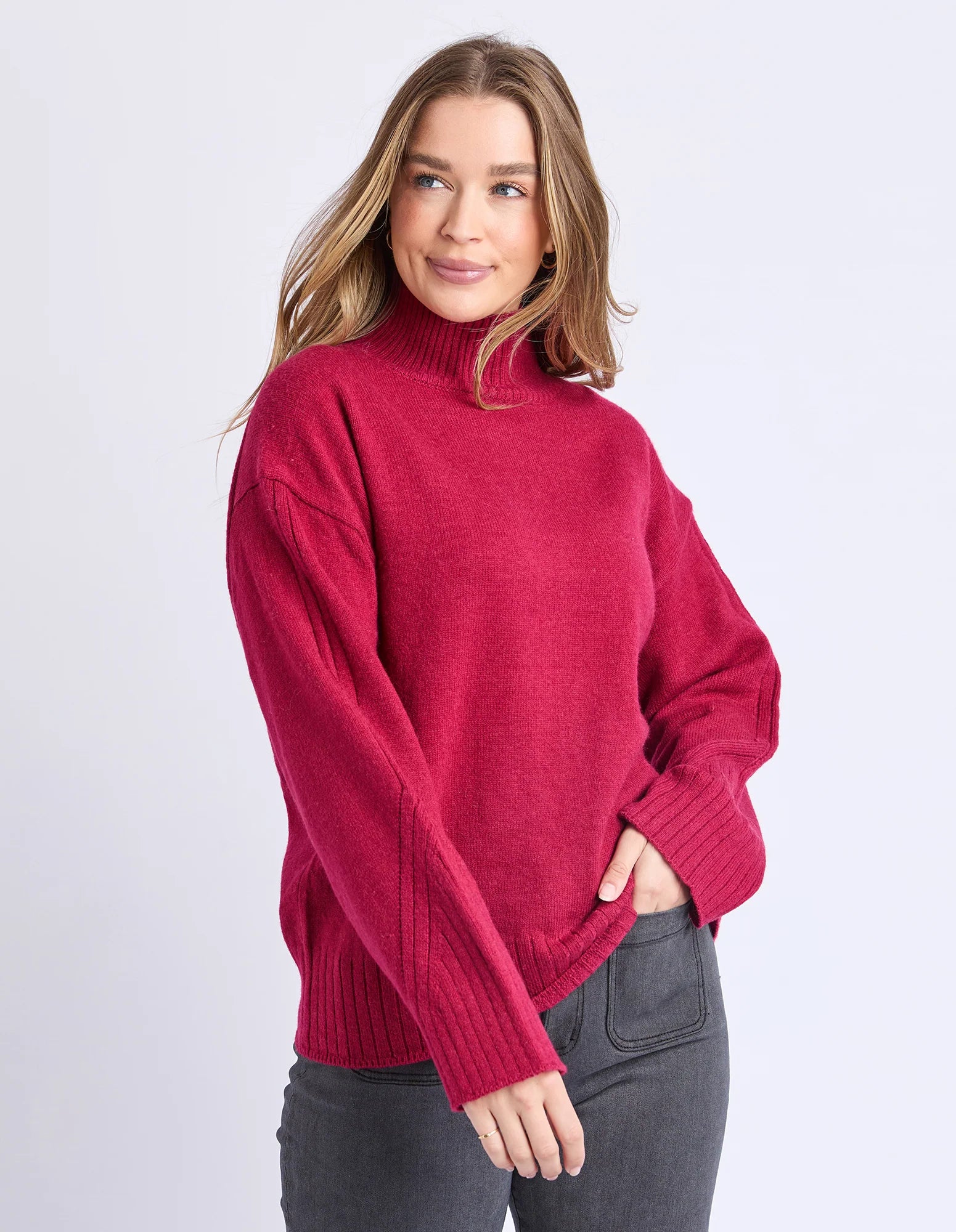 Image of Woman wearing a Foxwood red sweater on a light gray background