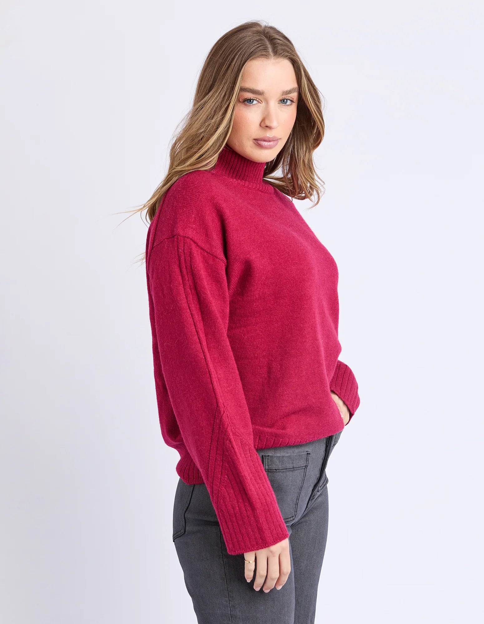 Image of Woman wearing a Foxwood red sweater on a white background