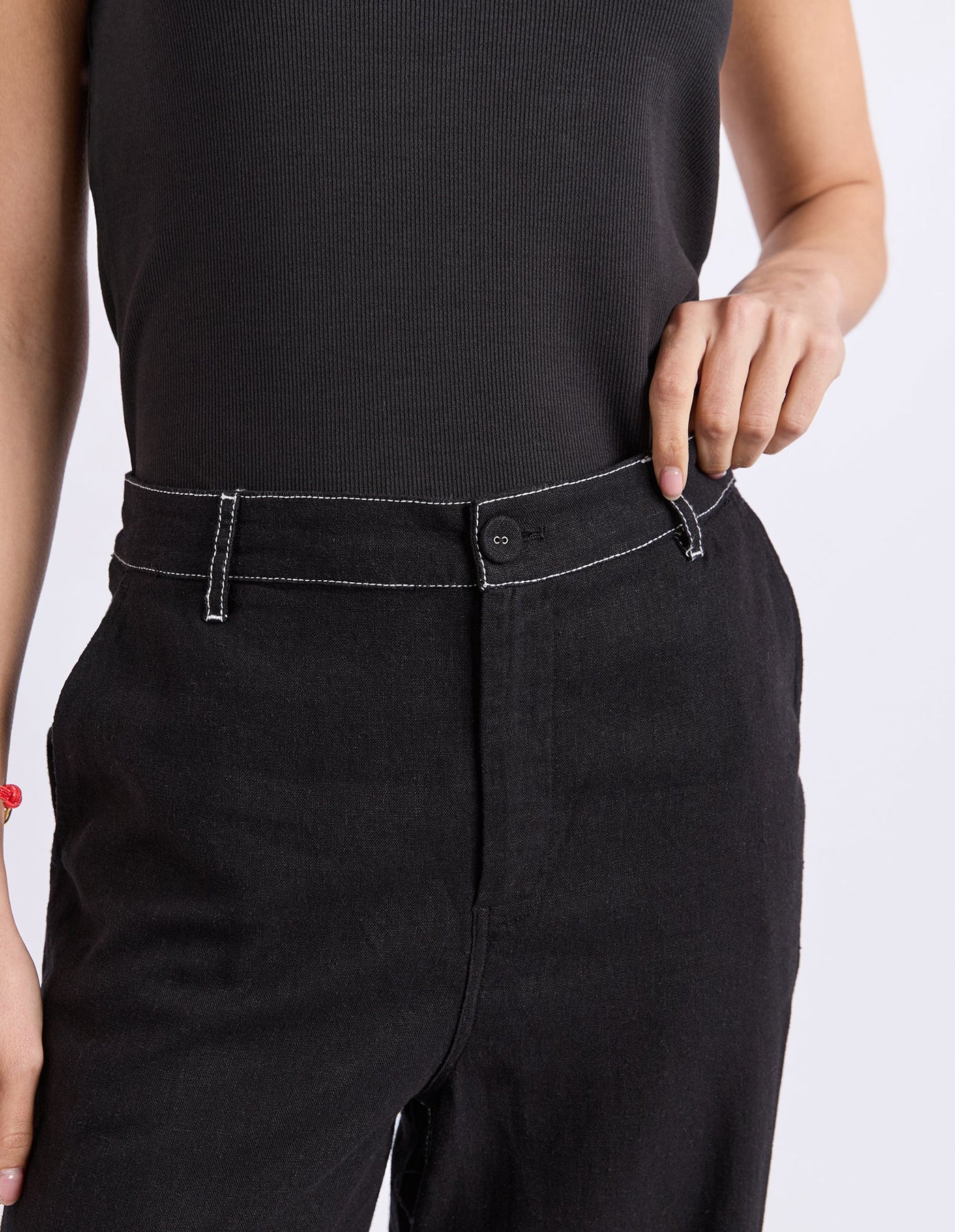 Image of Woman wearing black Foxwood wide leg pants paired with a plain top on a plain background