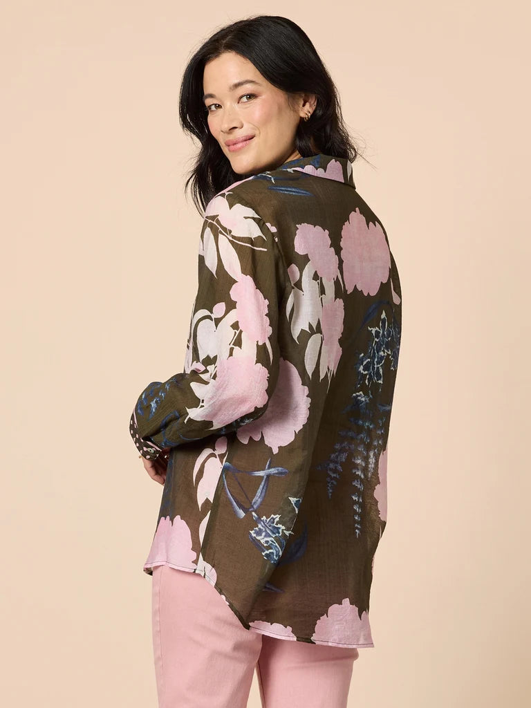 Woman wearing a Gordon Smith floral jacket with a beige background