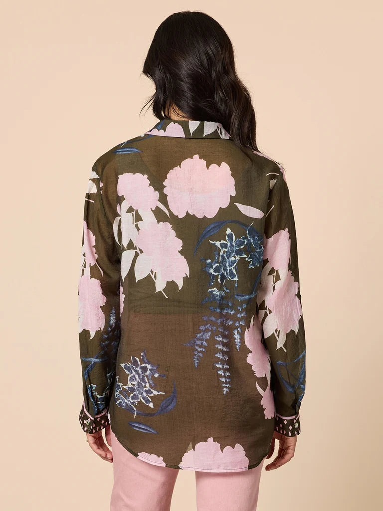 Image of Woman wearing a Gordon Smith floral patterned shirt on a beige background