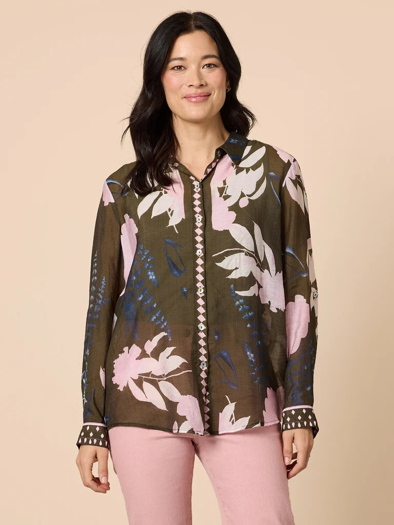 Woman wearing a Gordon Smith floral blouse with a beige background