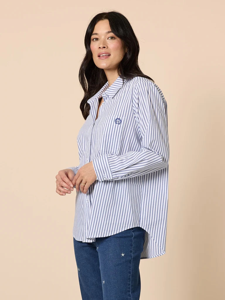 Image of Woman wearing a Gordon Smith blue and white striped shirt against a beige background