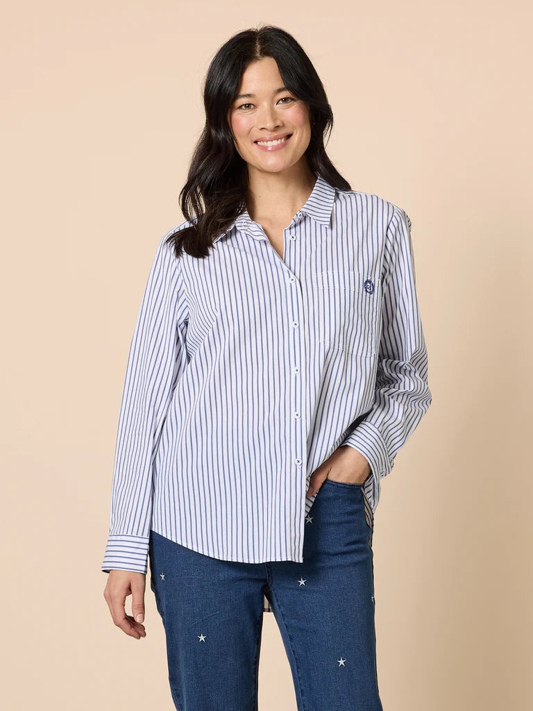 Image of Woman wearing a Gordon Smith blue and white striped shirt with a beige background