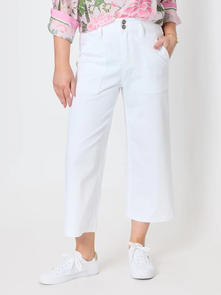 Image of Gordon Smith white cropped wide-leg pants with front patch pockets, shown on a model wearing a floral top and white sneakers against a plain light background.