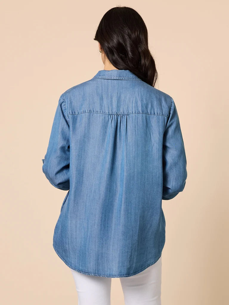 Image of Woman wearing a Gordon Smith denim shirt with a beige background