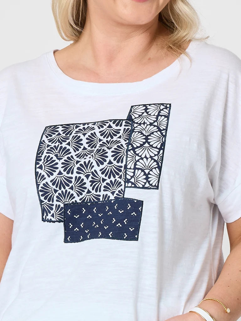 Image of A woman wearing a Gordon Smith white short-sleeve t-shirt with a graphic print of three patterned fabric squares in navy blue and white.