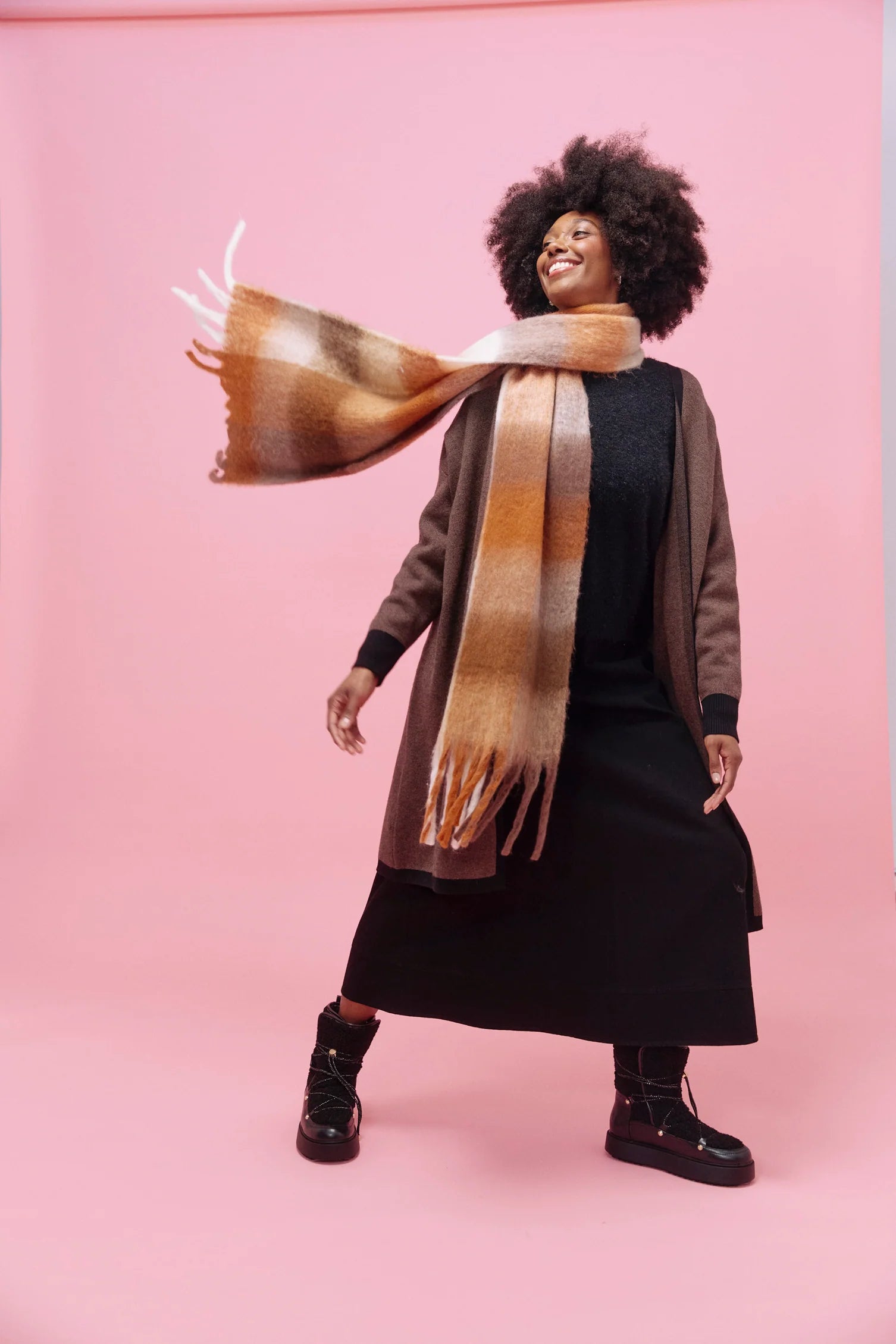 Image of Model wearing Haven check scarf on a pink background