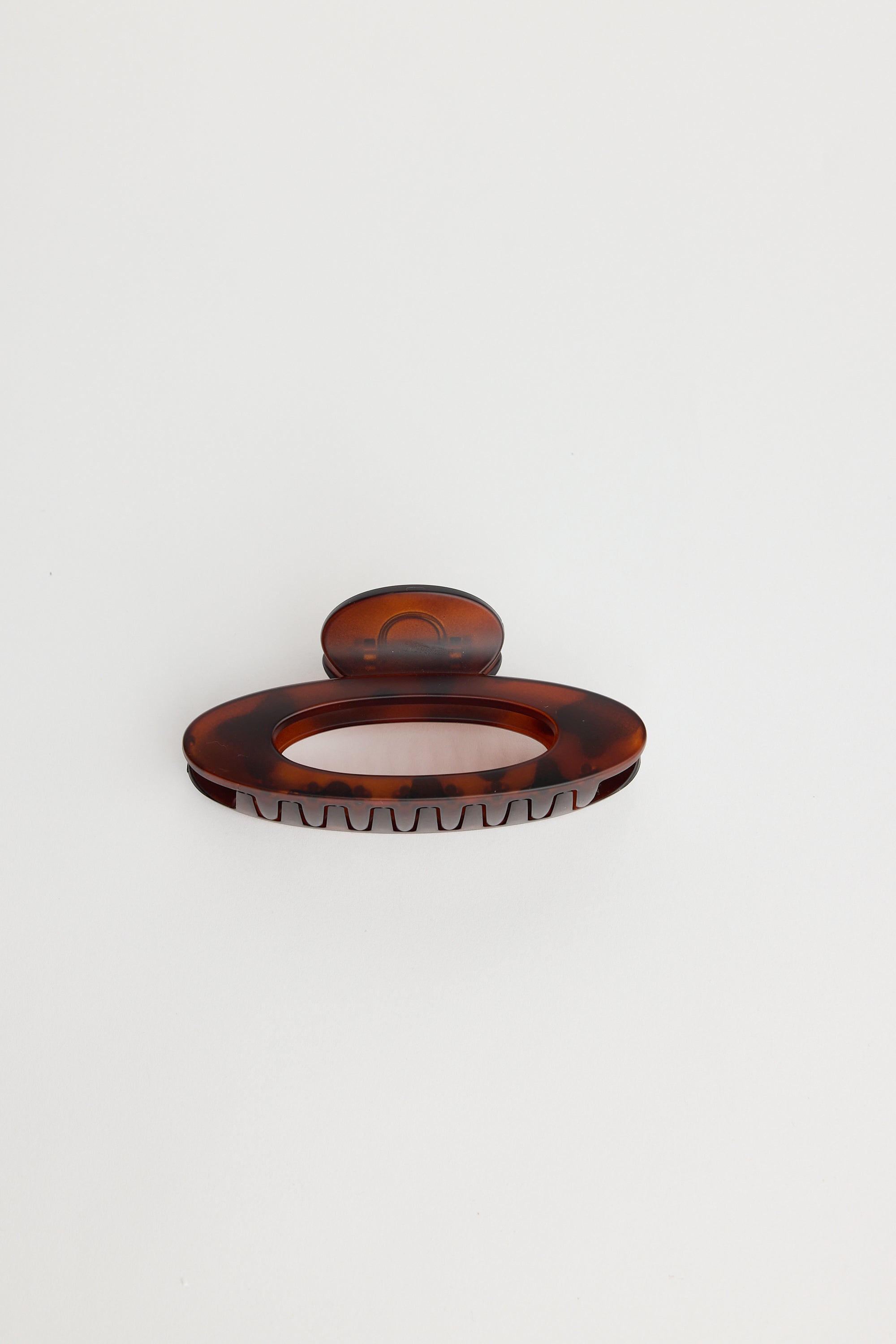 Image of Holiday Life Chocolate hairclip with a textured surface on a white background