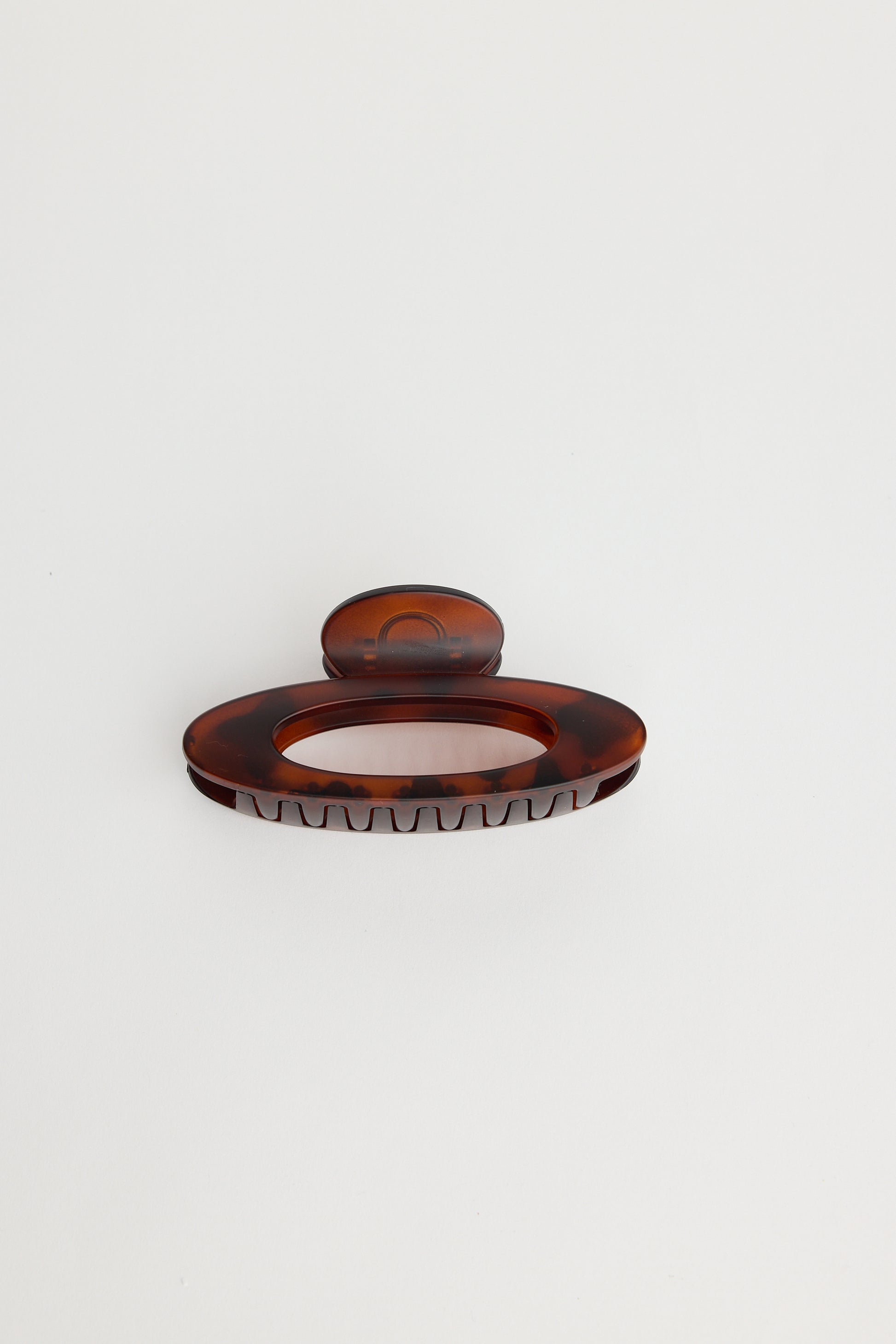 Holiday Life Chocolate hairclip with a textured surface on a white background