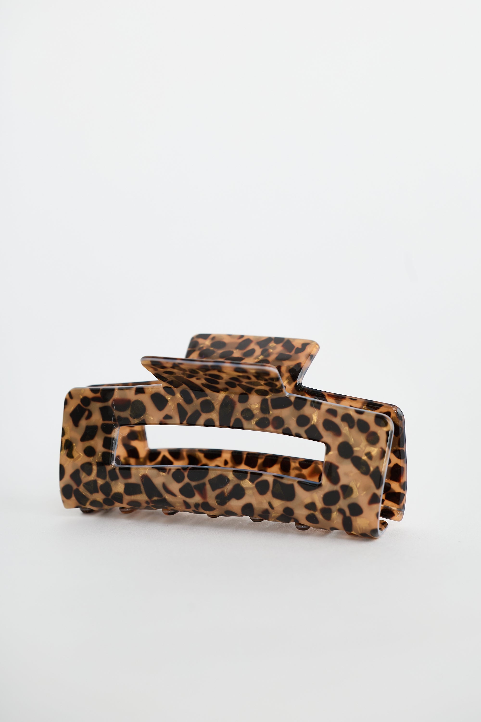 Collection of Holiday Life Leopard print hair clip on a white background in a gallery layout