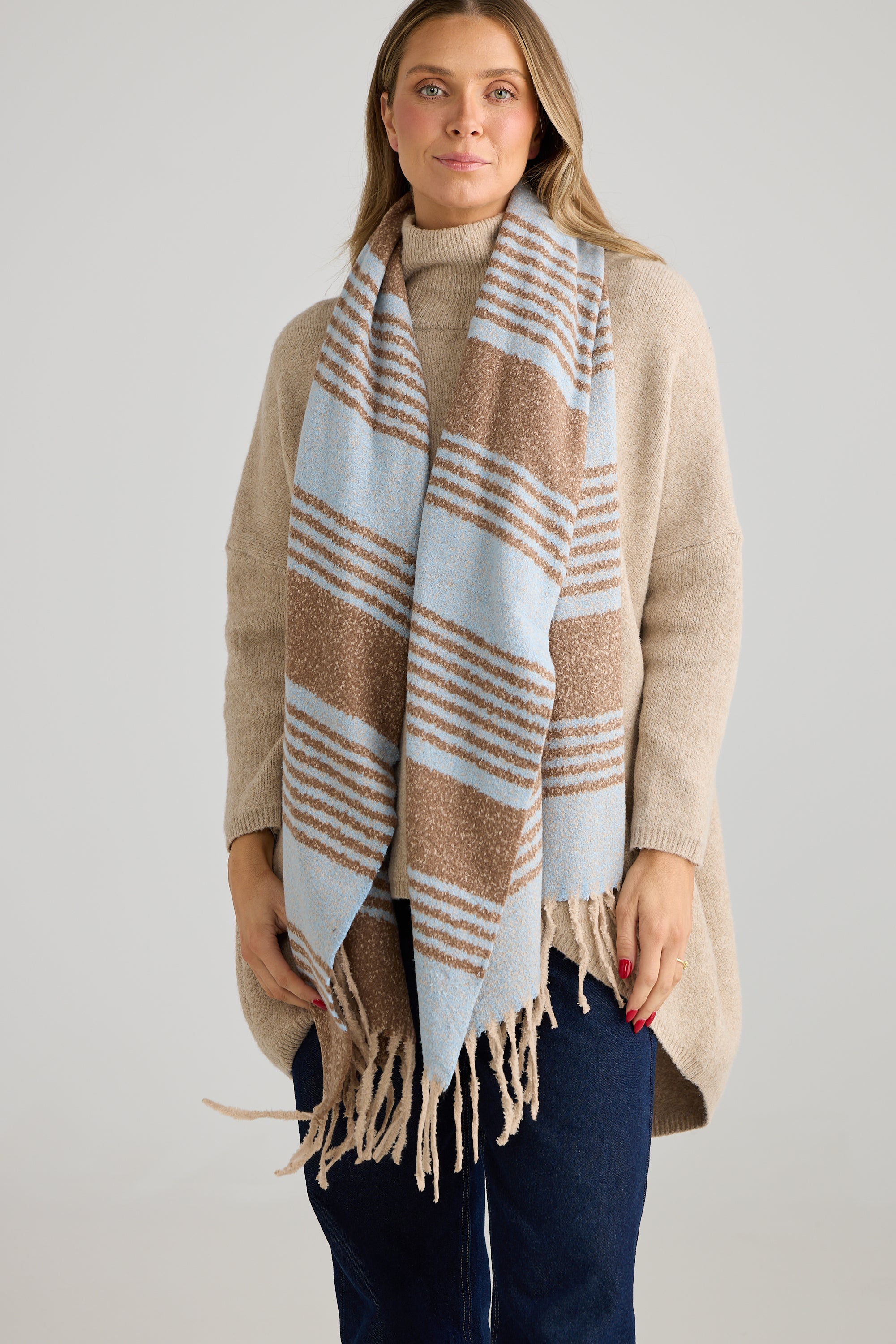 Image of Woman wearing a Holiday Life plaid scarf with a neutral background