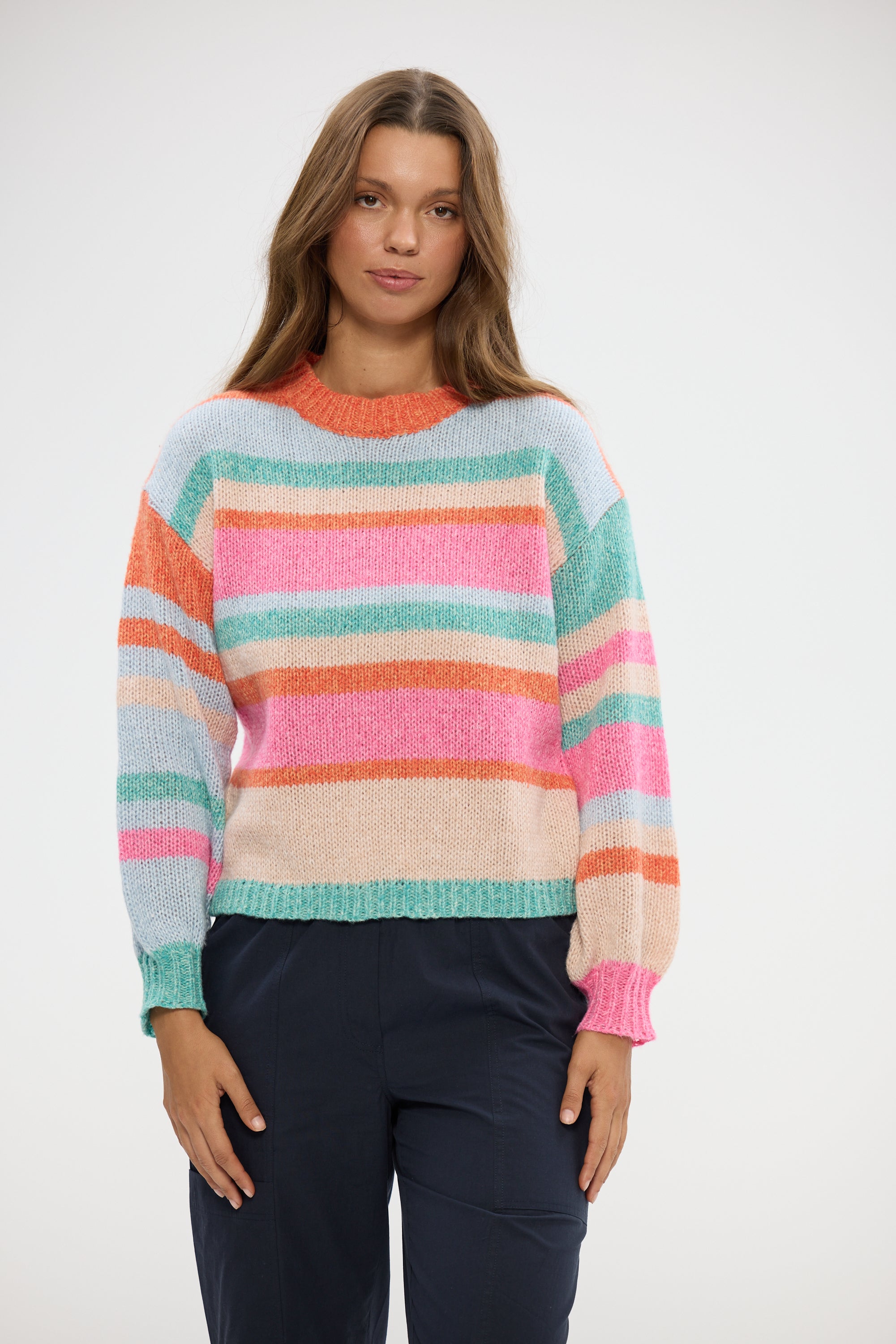 Image of Woman wearing a Holiday colorful striped sweater on a white background