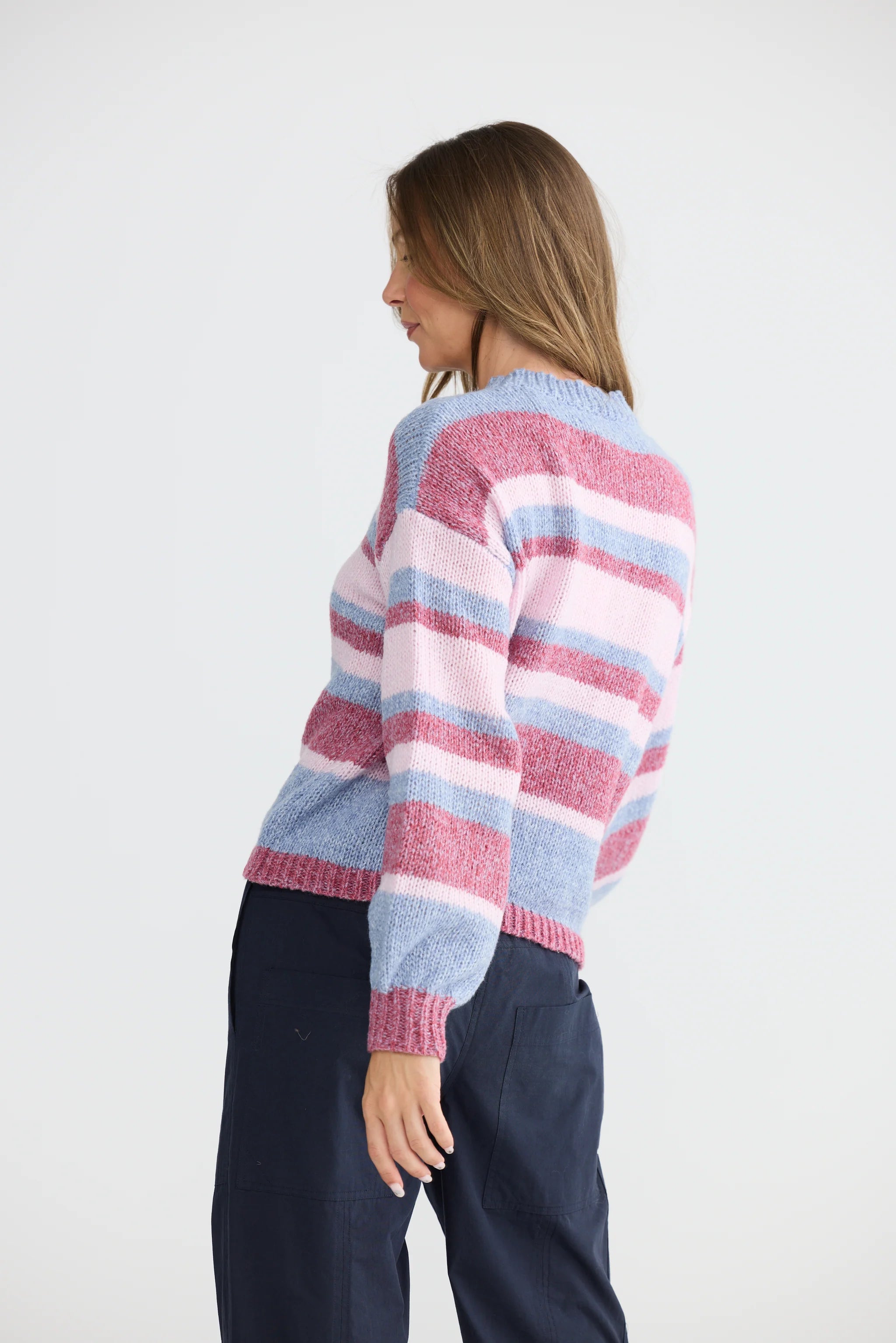 Image of Woman wearing a Holiday colorful striped sweater on a white background